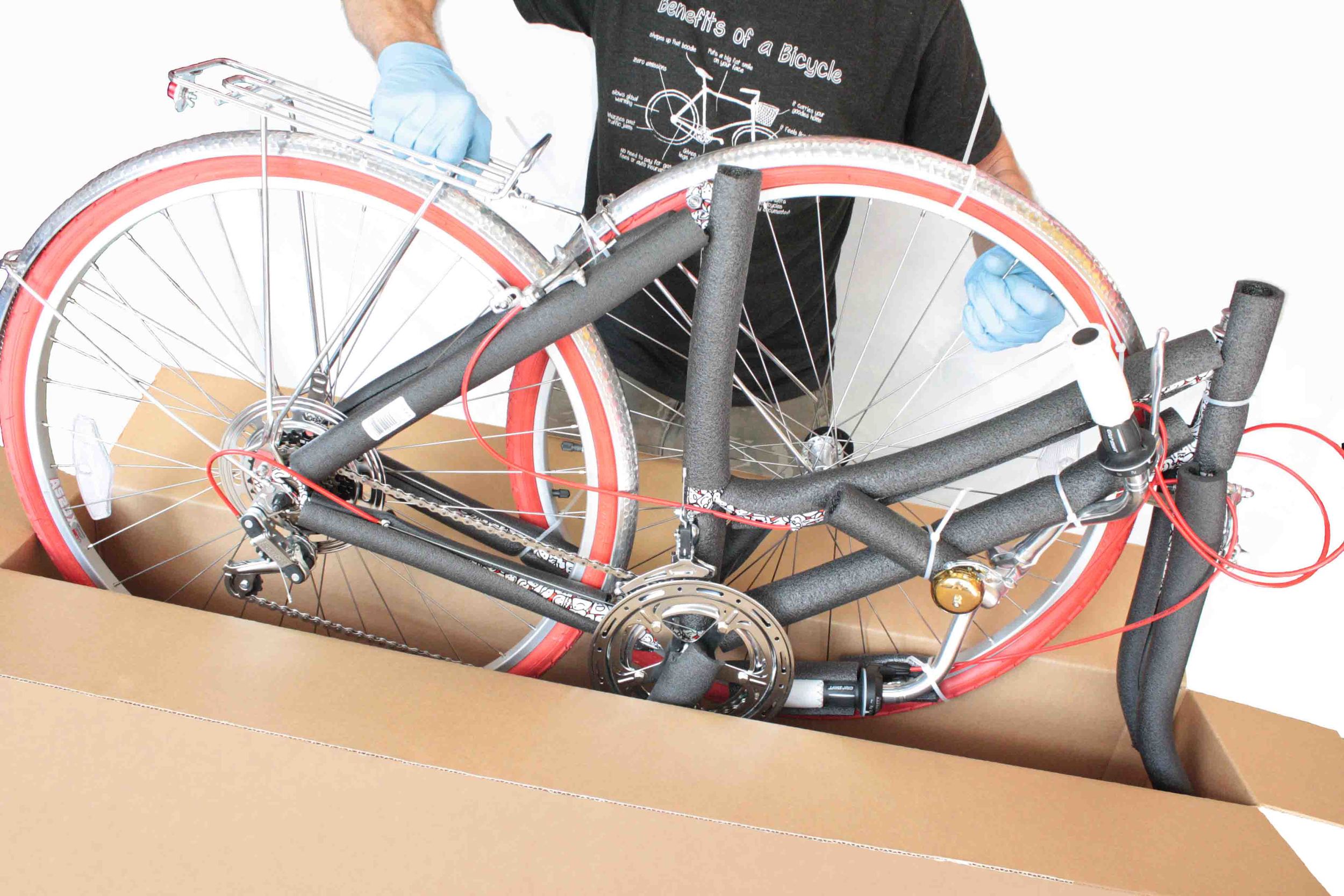 Carefully lift the bicycle out of the box. 