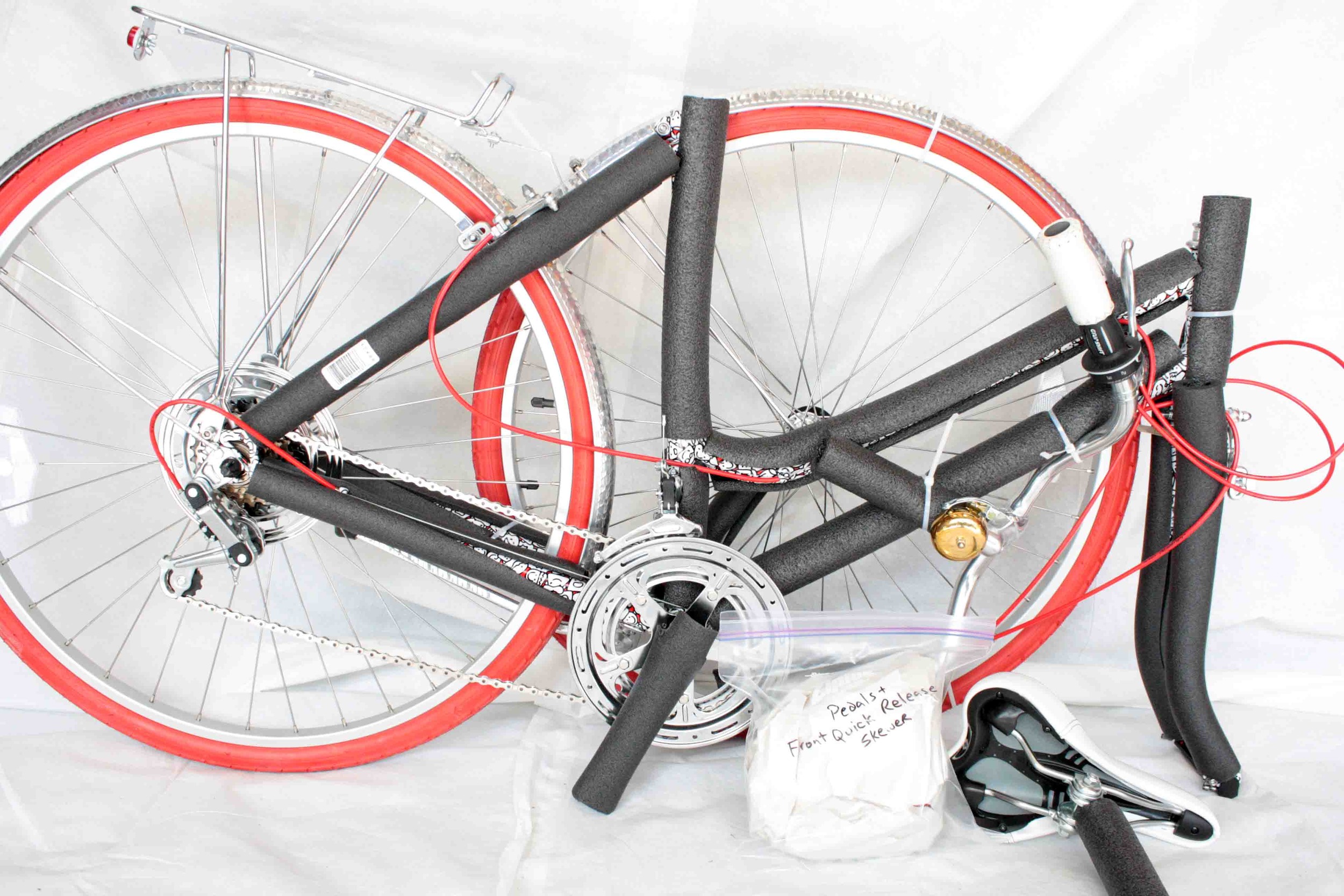 Set aside the bag containing the pedals and front quick release.