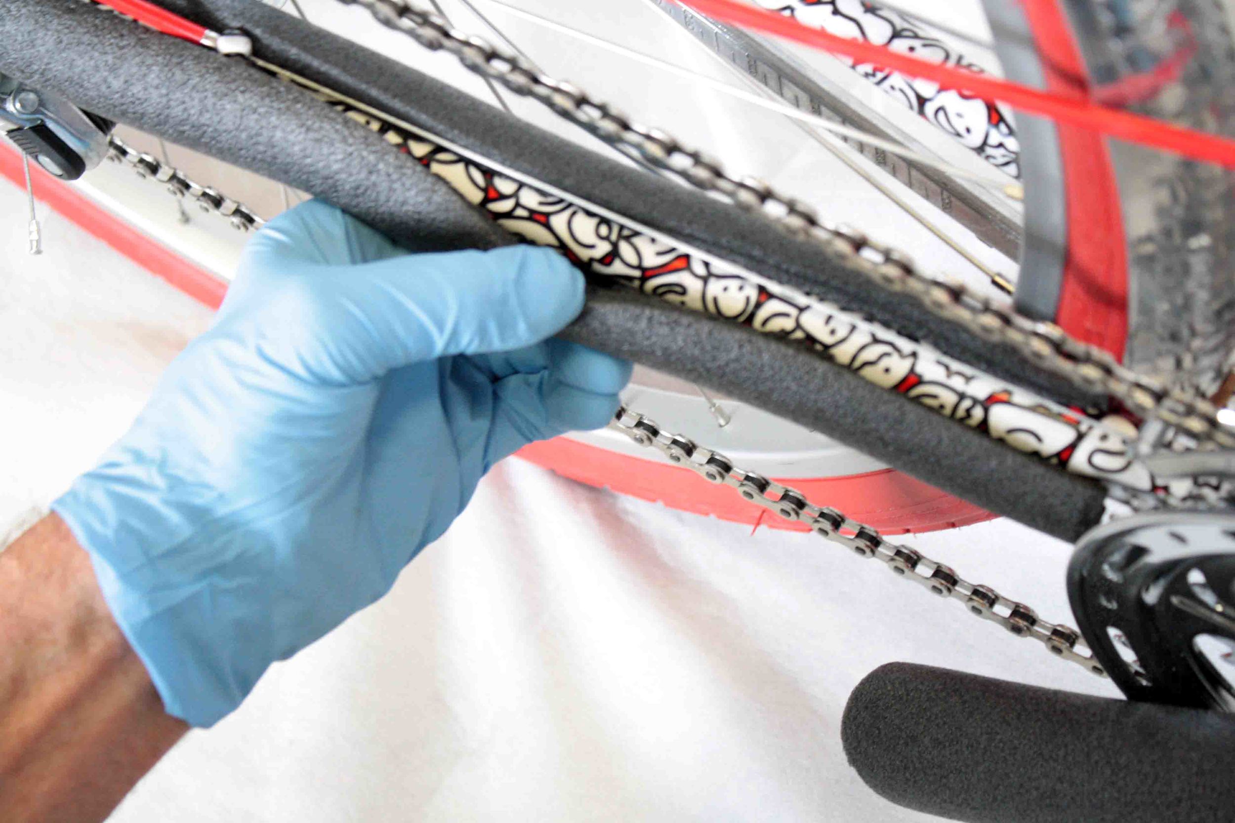 Remove the packaging material and carefully cut all zip-ties, being sure not to scratch the frame. Keep the bicycle upright.