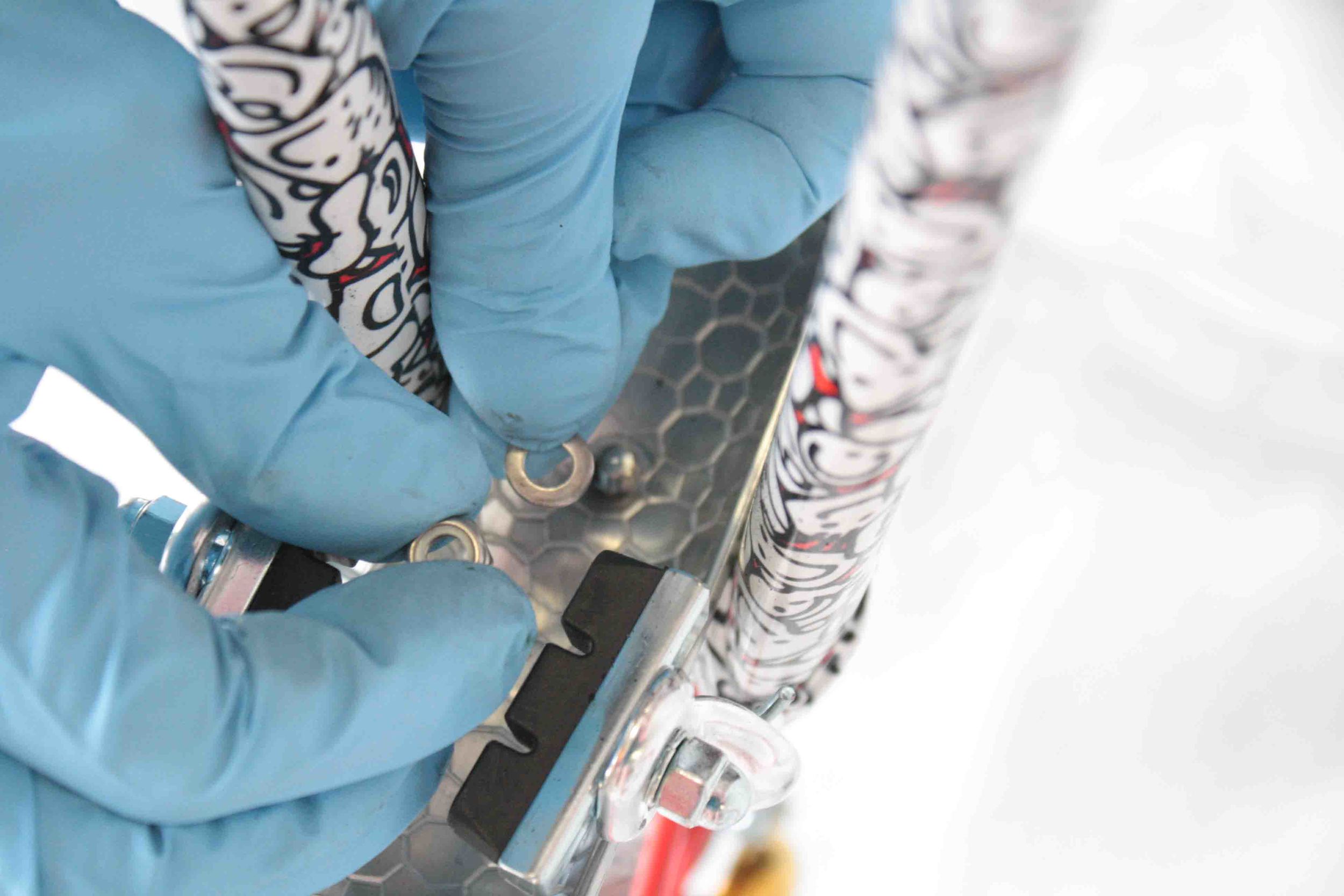 Place the washer and then the nut onto the bolt and tighten securely using the 10mm socket tool or wrench.