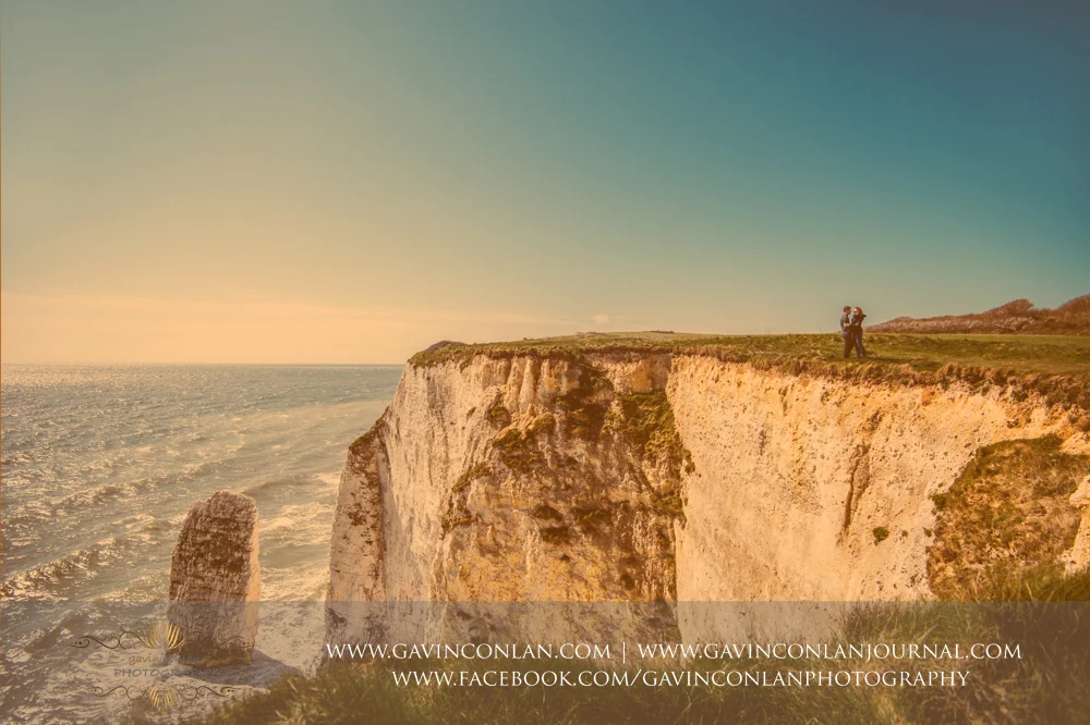 creative fine art portrait of Victoria and James cuddling next to the cliffs edge at Old Harry Rocks . Engagement Session in Bournemouth, Dorset by gavin conlan photography Ltd