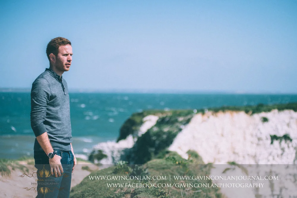 portrait of James looking out to the Solent at Old Harry Rocks . Victoria and James Engagement Session in Bournemouth, Dorset by gavin conlan photography Ltd