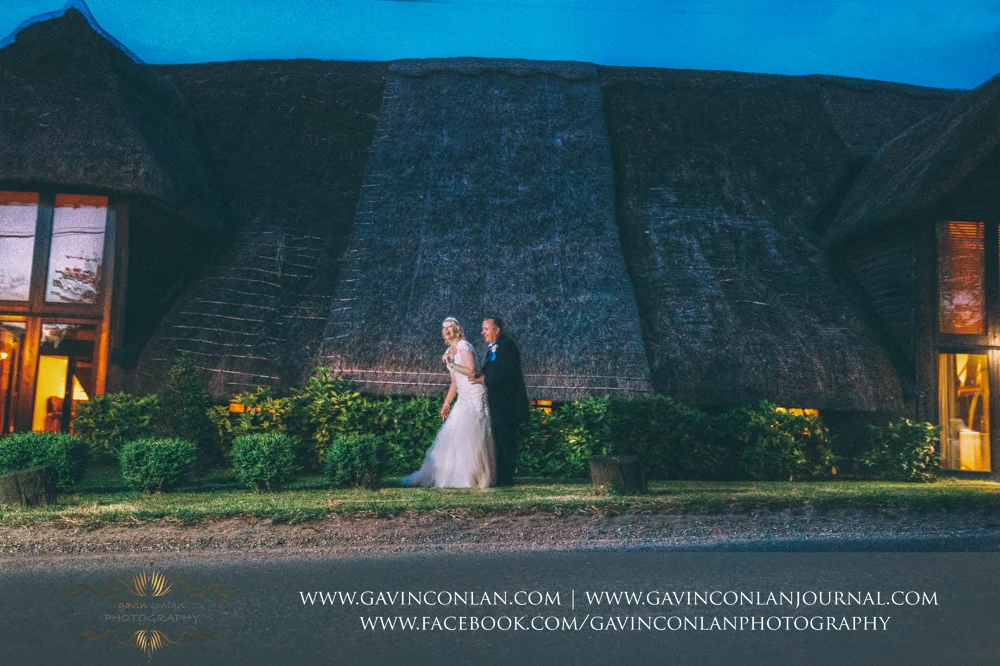creative night time portrait of the bride and groom outside The Barn having fun together. Wedding photography at The Barn Brasserie by Essex wedding photographer gavin conlan photography Ltd