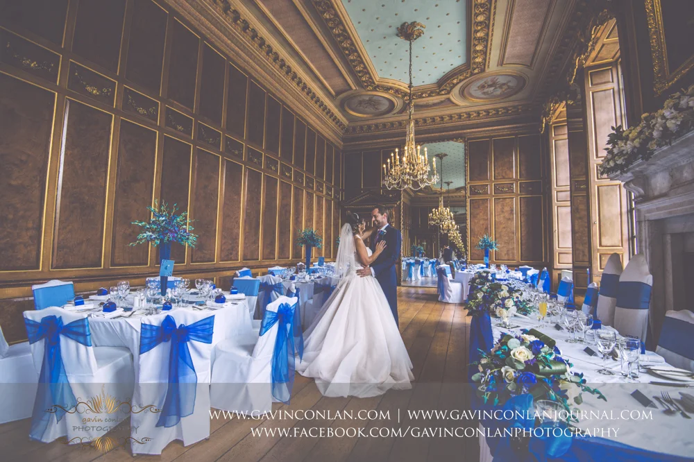 creative portrait of the bride and groom sharing a moment in the ballroom before the wedding breakfast. Wedding photography at Gosfield Hall by Essex wedding photographer gavin conlan photography Ltd