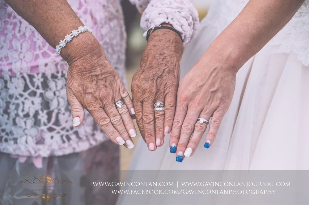 timeless and elegant legacy portrait of the showcasing the hands and wedding rings of the bride, her mother and her grandmother. Wedding photography at Gosfield Hall by Essex wedding photographer gavin conlan photography Ltd