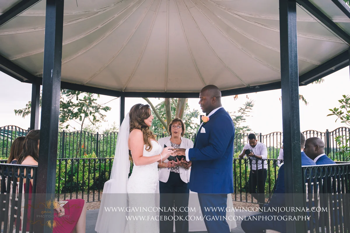 creative ceremony portrait showing the bride putting the wedding ring on her grooms finger on The Lawn at Stock Brook Country Club. Wedding photography at Stock Brook Country Club by gavin conlan photography Ltd 