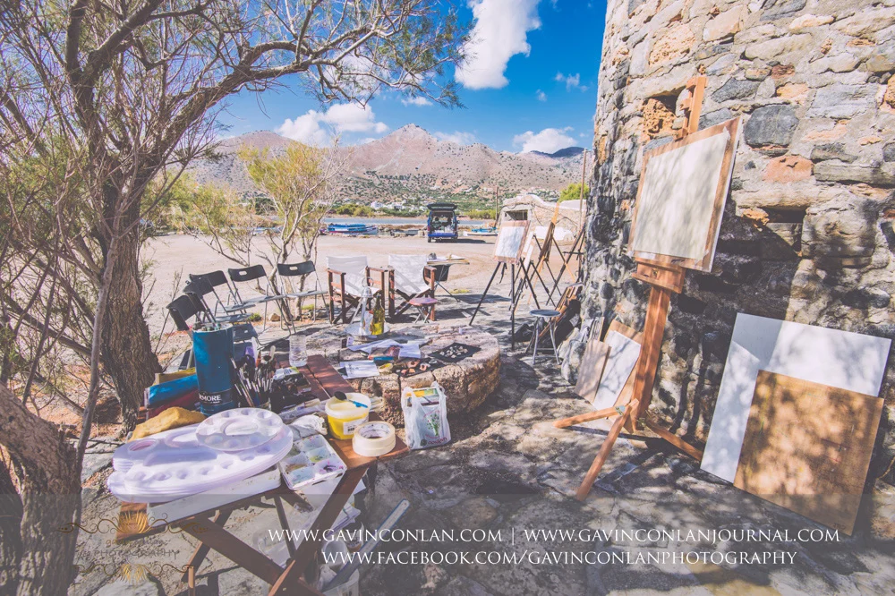 The wedding party taking an art lesson by Visual Arts Crete and showcasing their artisic talent in Crete, Greece by gavin conlan photography Ltd