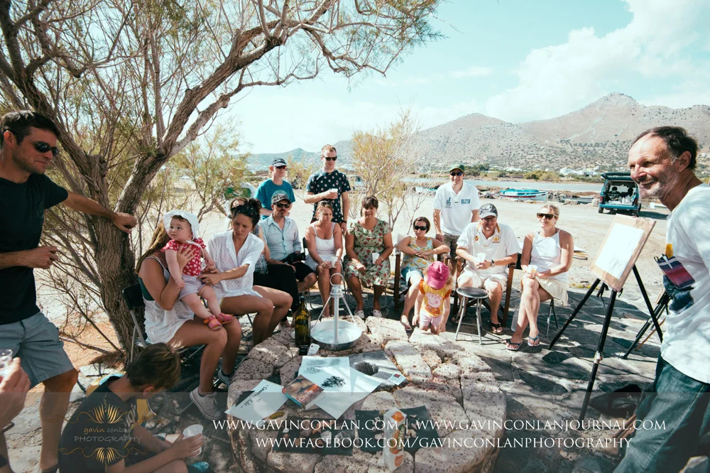 The wedding party taking an art lesson by Visual Arts Crete and showcasing their artisic talent in Crete, Greece by gavin conlan photography Ltd