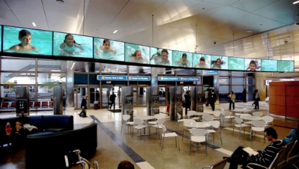 Play document of SPLASH, a 28-channel video installation at the Tom Bradley International Terminal at the Los Angeles International Airport