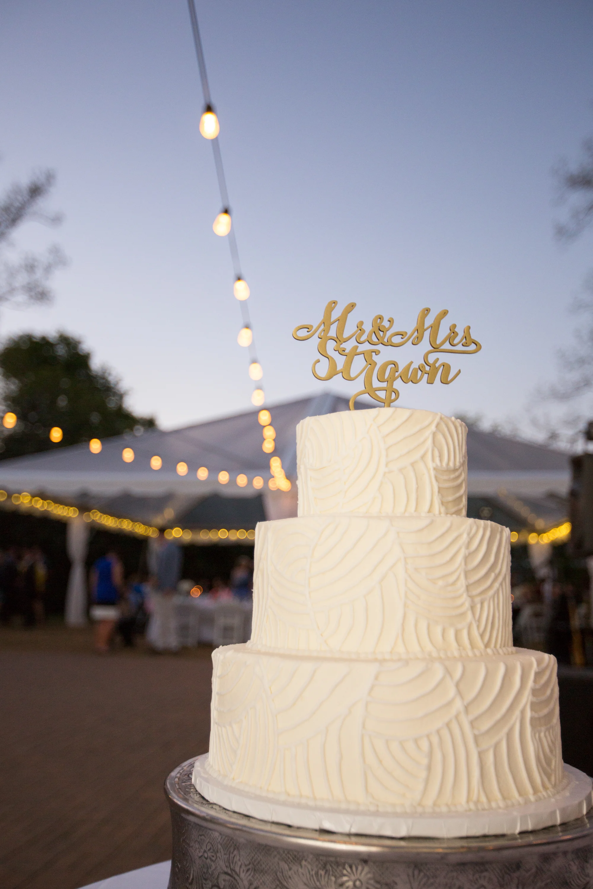 Watching the sun set over the party through the clear top tent via Barron's Rental . Cake by Classic City Confections