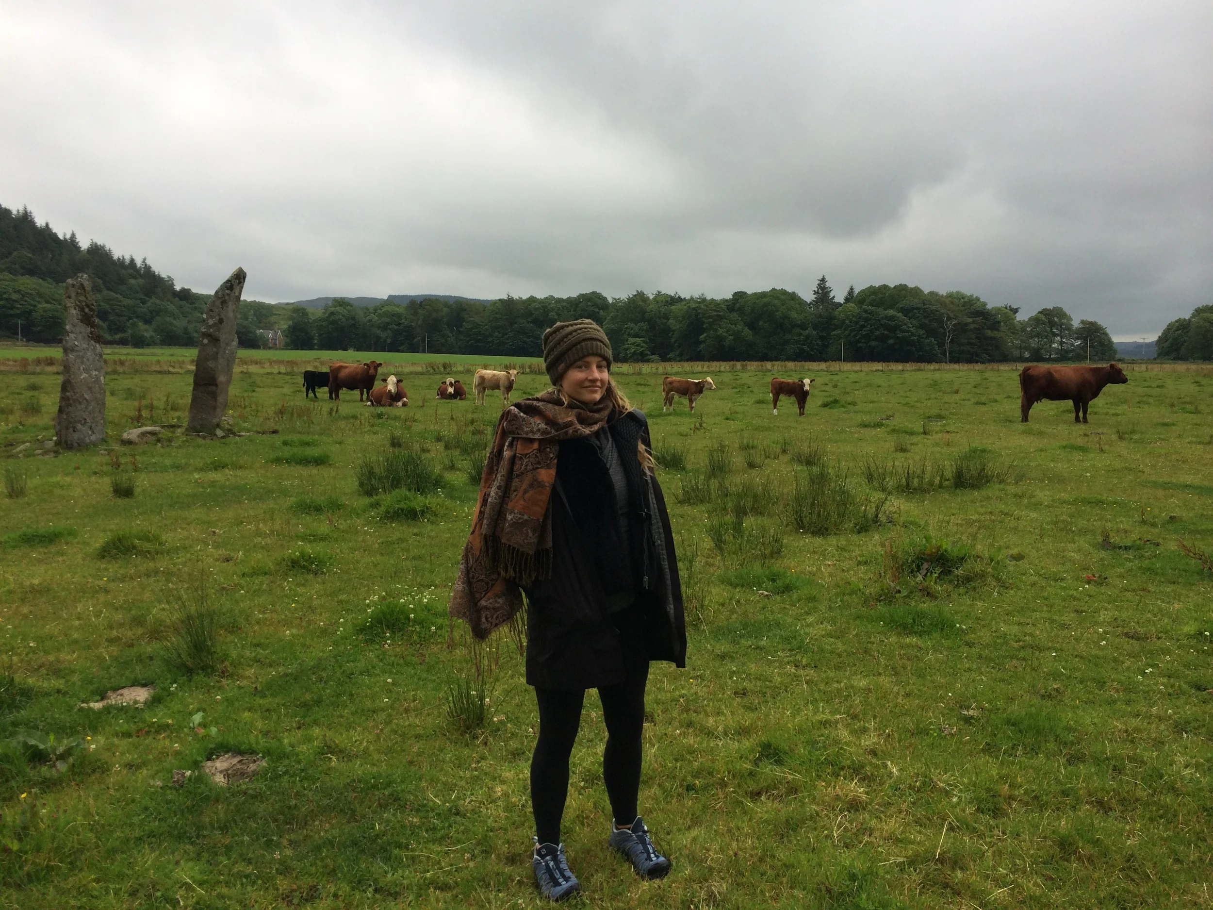 Me and an impressive circle of standing stones in a random cow field in Kilmartin.