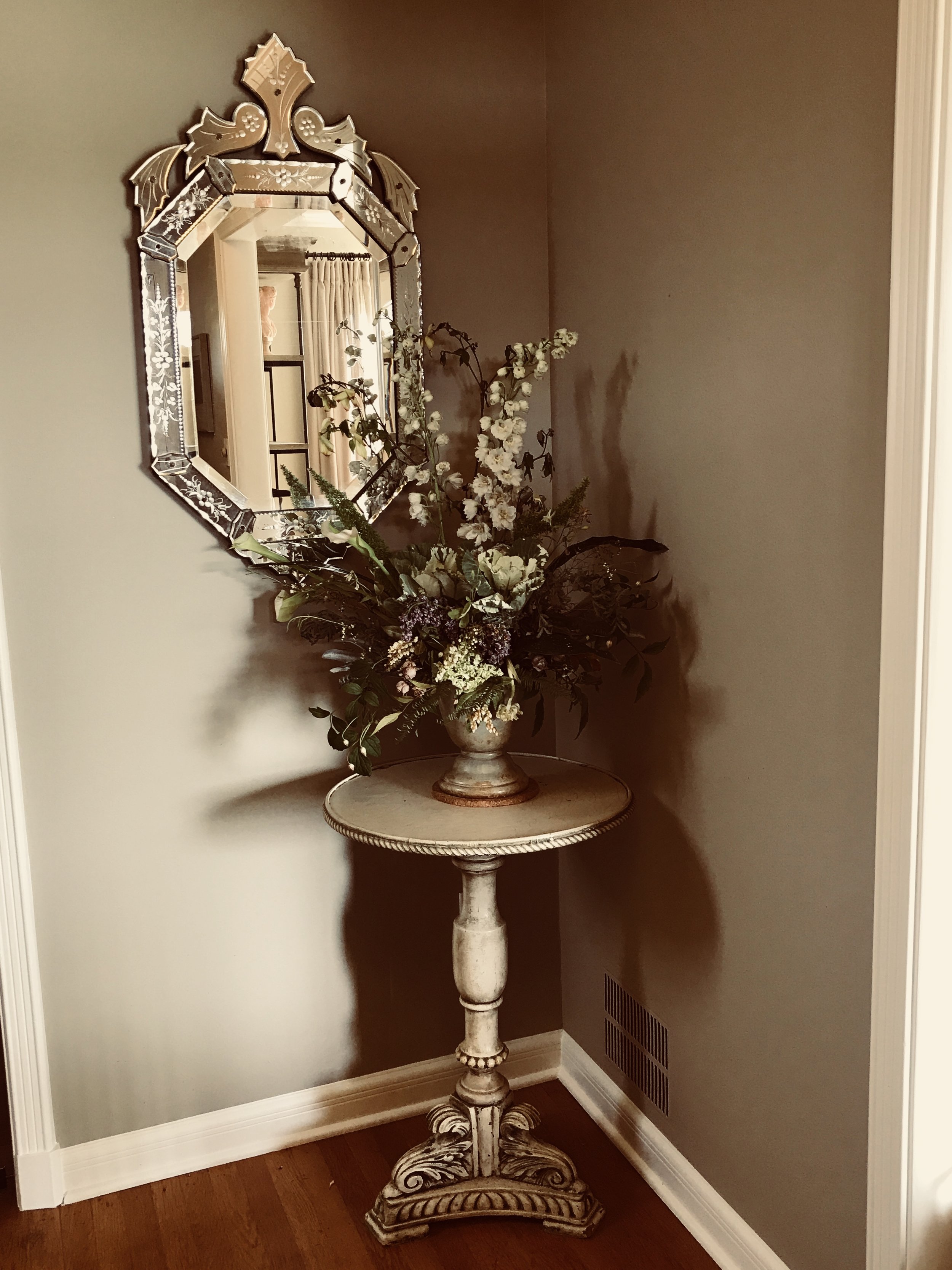  A Venetian mirror and antique Italian table welcome visitors 