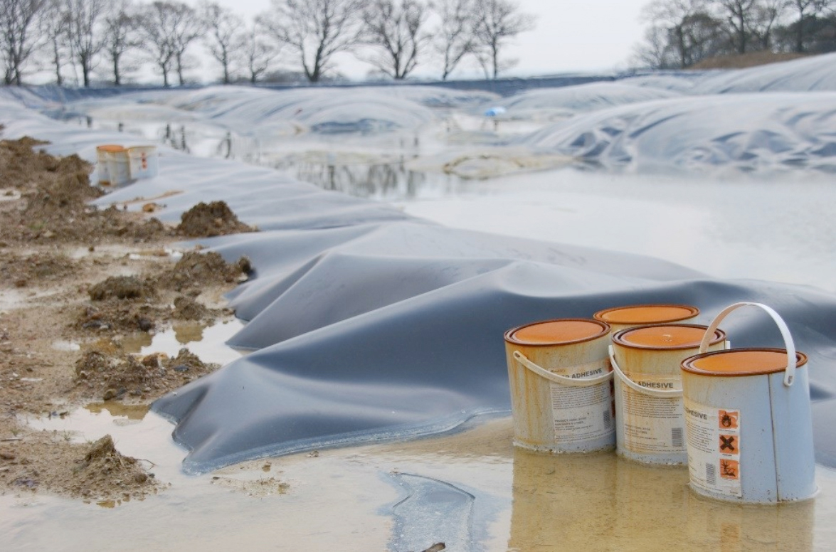 Rusting tins of toxic chemicals next to the lagoon
