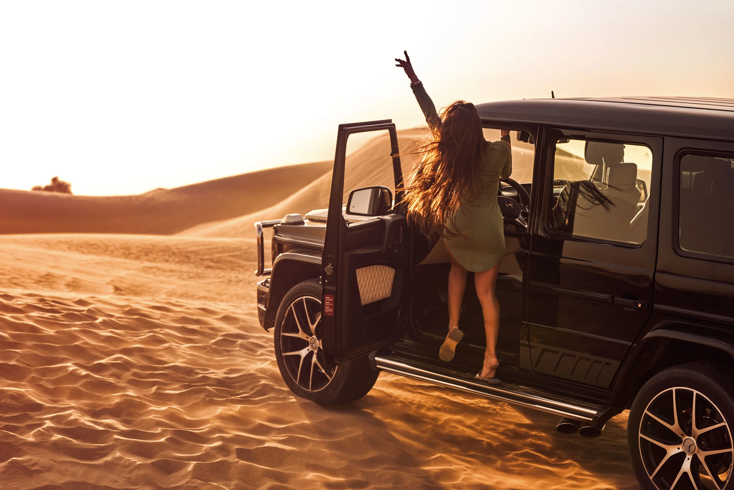 girl-stand-on-gwagon-sunset.jpg