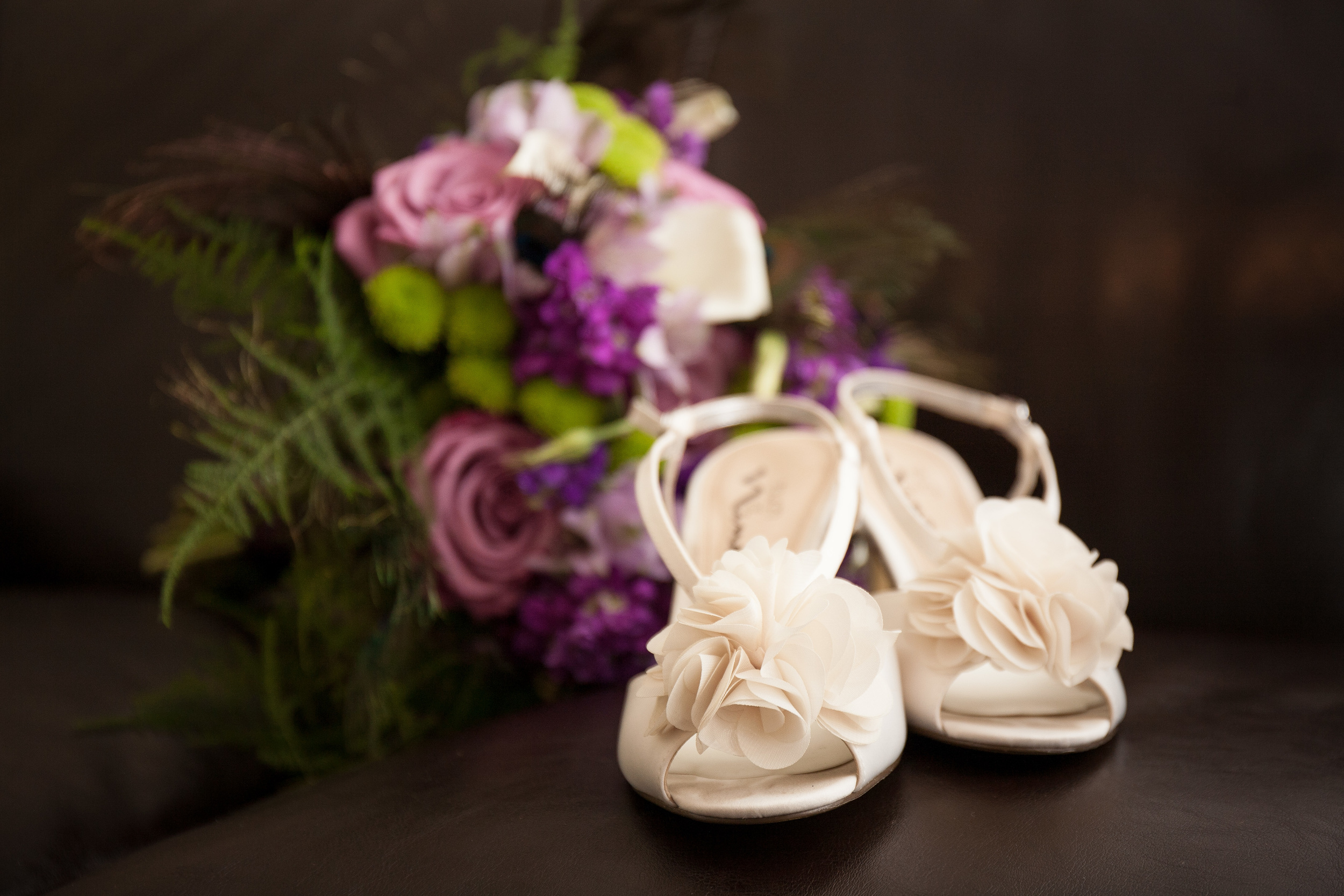 The Kyle House Fincastle Virginia Wedding Photographer Bent-Lee Carr wedding shoes in front of bridal bouquet