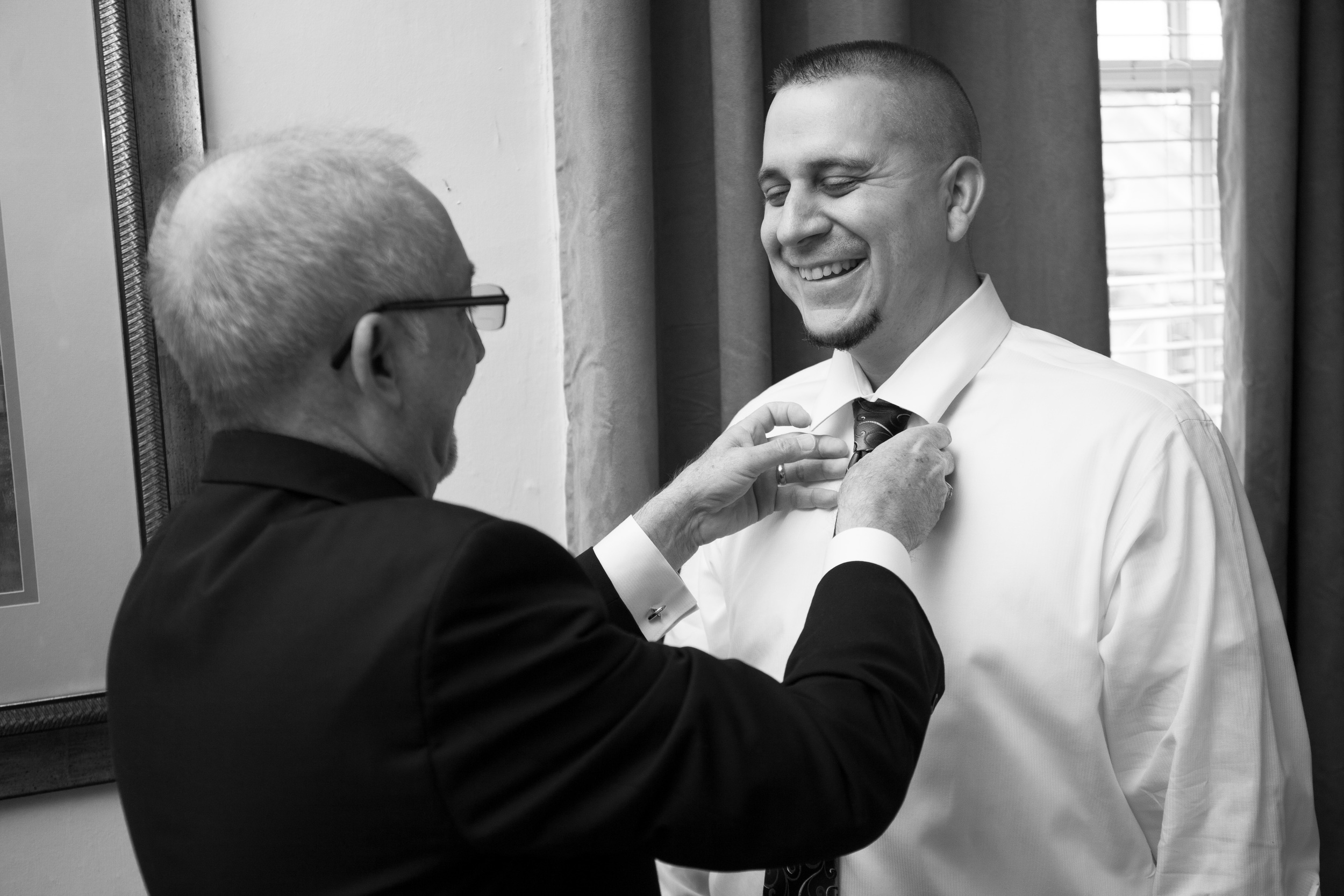 The Kyle House Fincastle Virginia Wedding Photographer Bent-Lee Carr father of the bride helping groom with his tie
