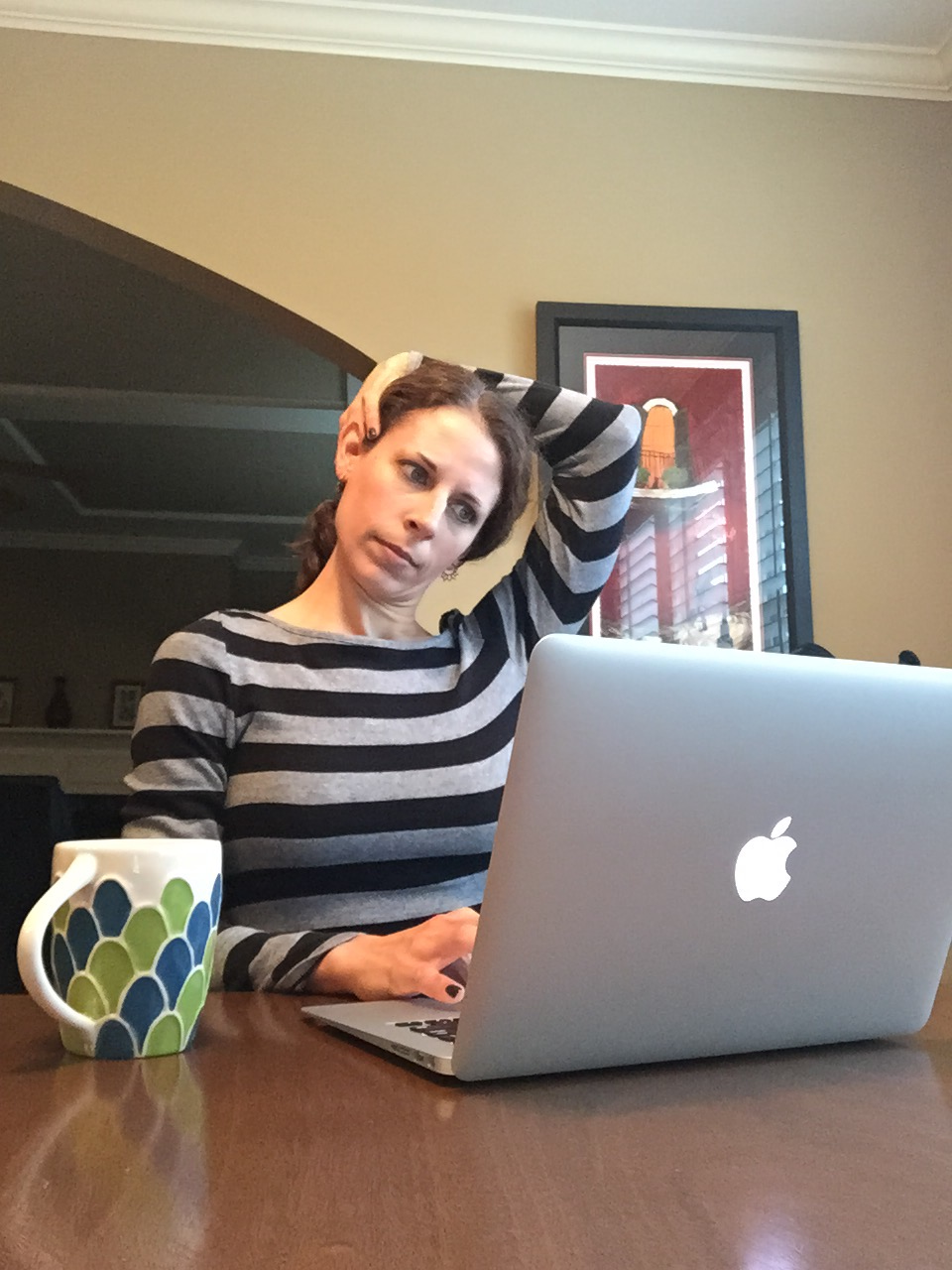 Here I am first thing in the morning, drinking coffee and checking email, and enjoying a nice neck stretch.