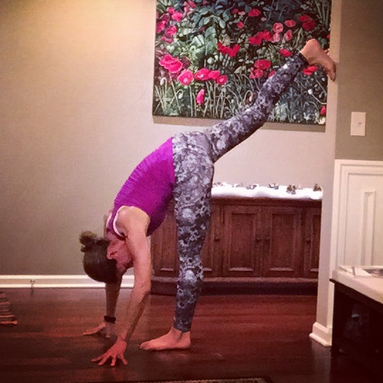 Let me just say that without the wall for help, my leg would probably be at least a foot lower. I actually really do like this pose as a transition, but preferably in a yoga studio with no mirrors so I don't have to see how pitifully low my leg is. Here's gumby lady to show y'all how it's done.