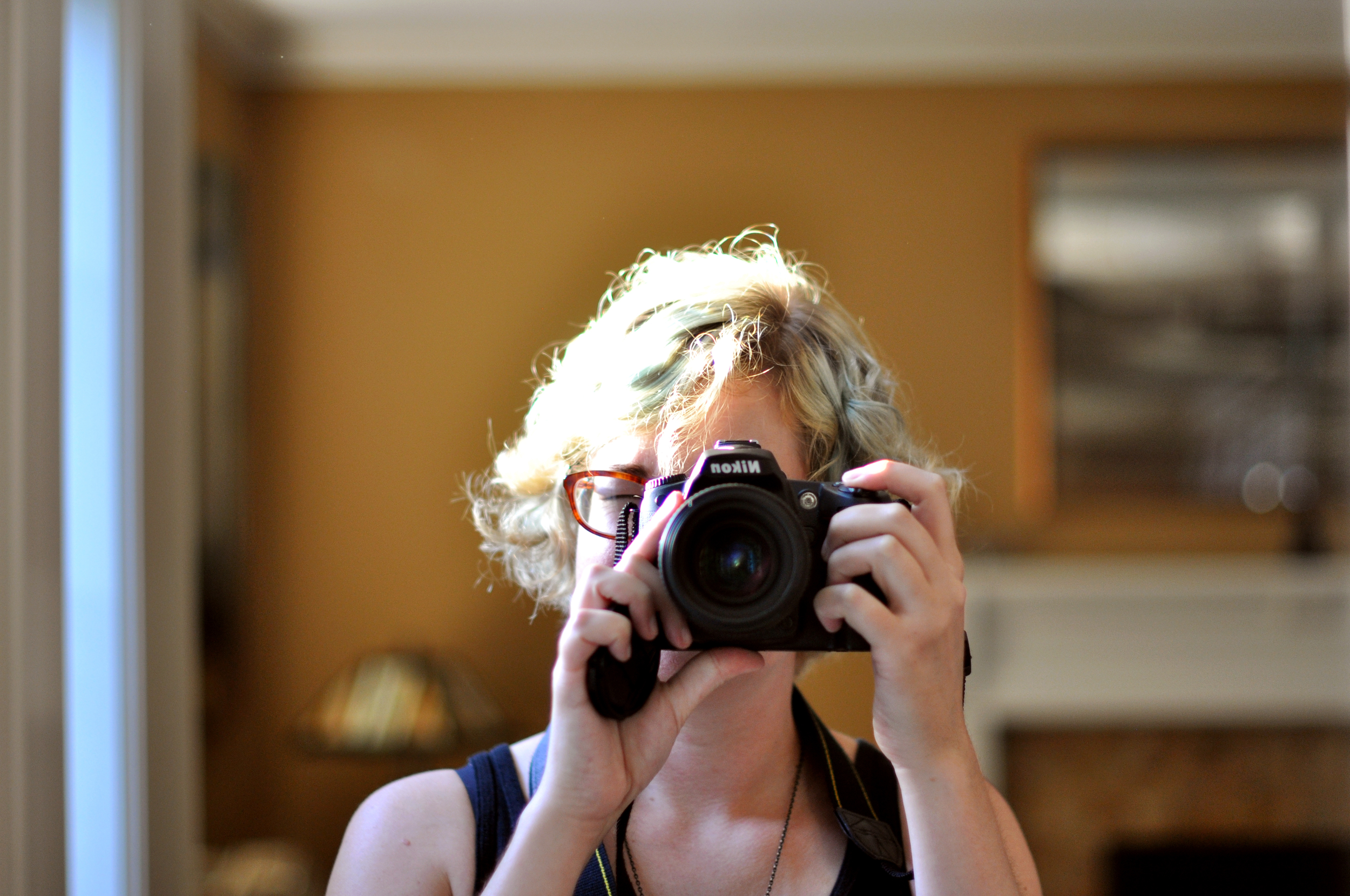 Obligatory self-portrait of camera in mirror with hair so bright it disappears in the light sensors.