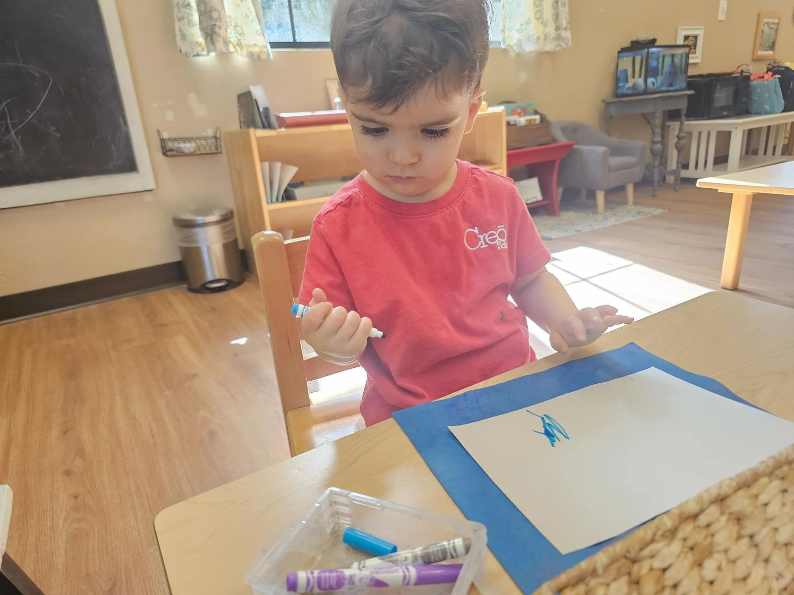 Sebastian scribbling with markers.jpg