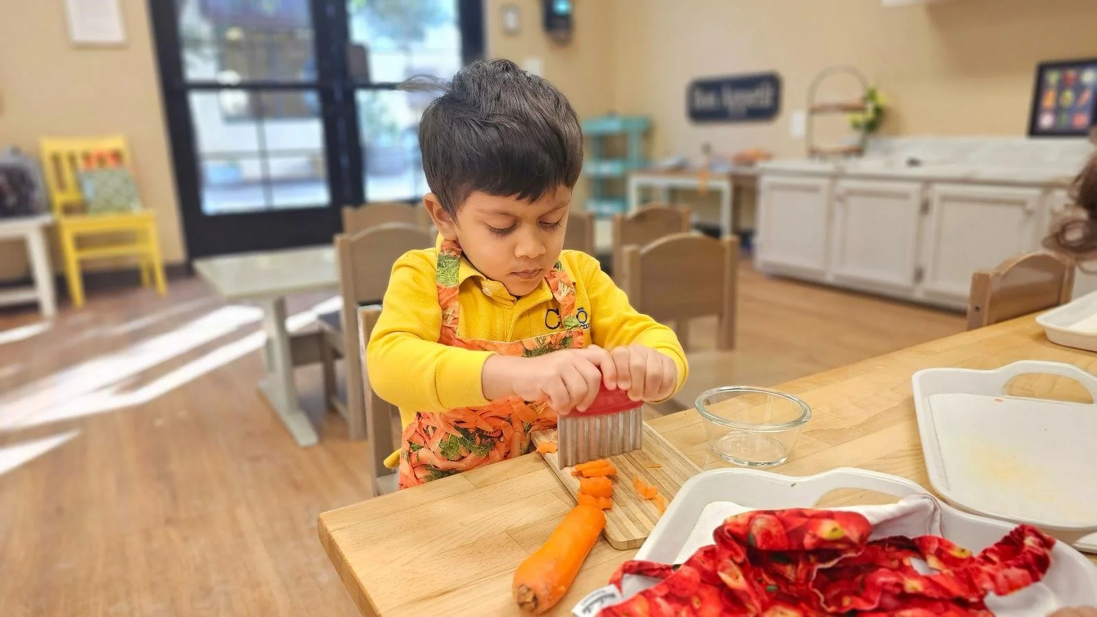 Shivam peeling and slicing carrots.jpg