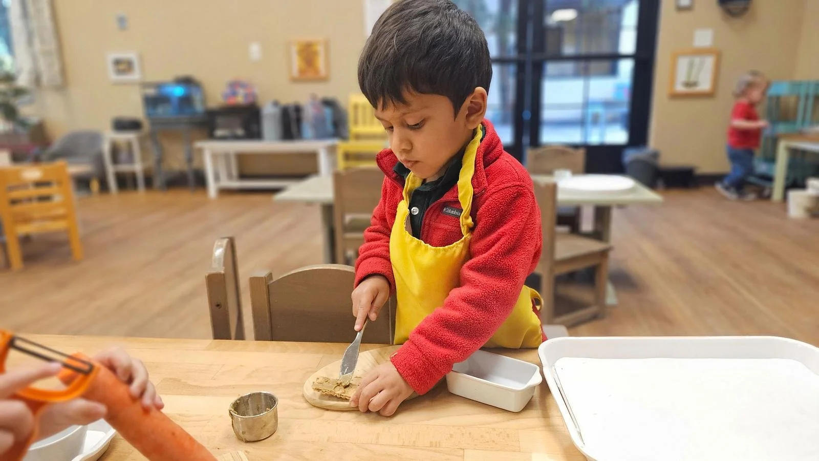 Shivam spreading sunbutter on crackers.jpg