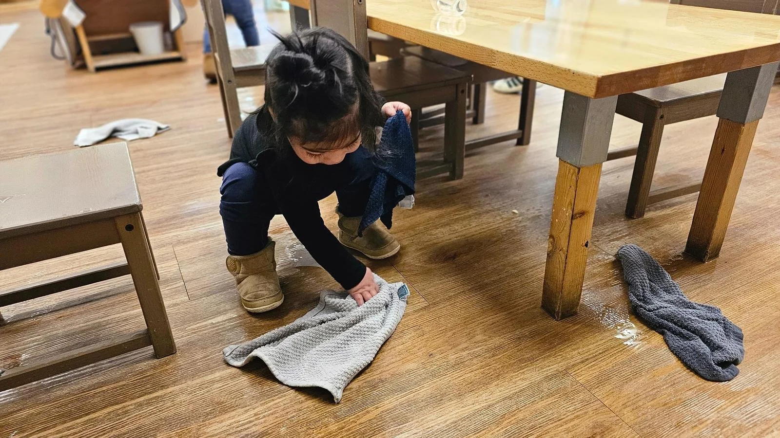 Avery wiping up a spill on floor.jpg
