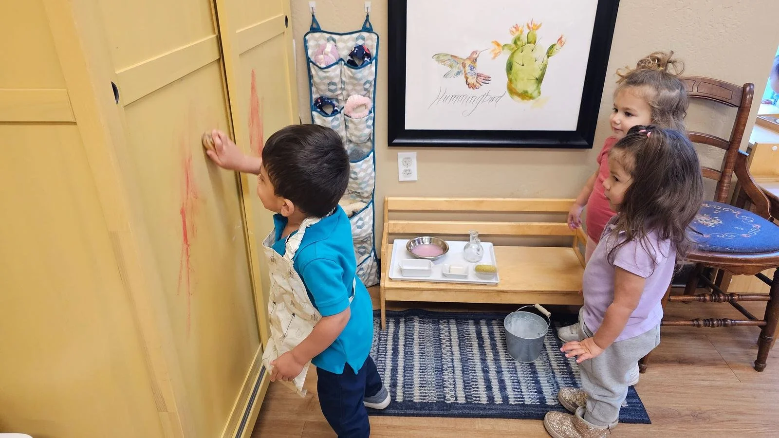 Shivam washing paint off closet door.jpg