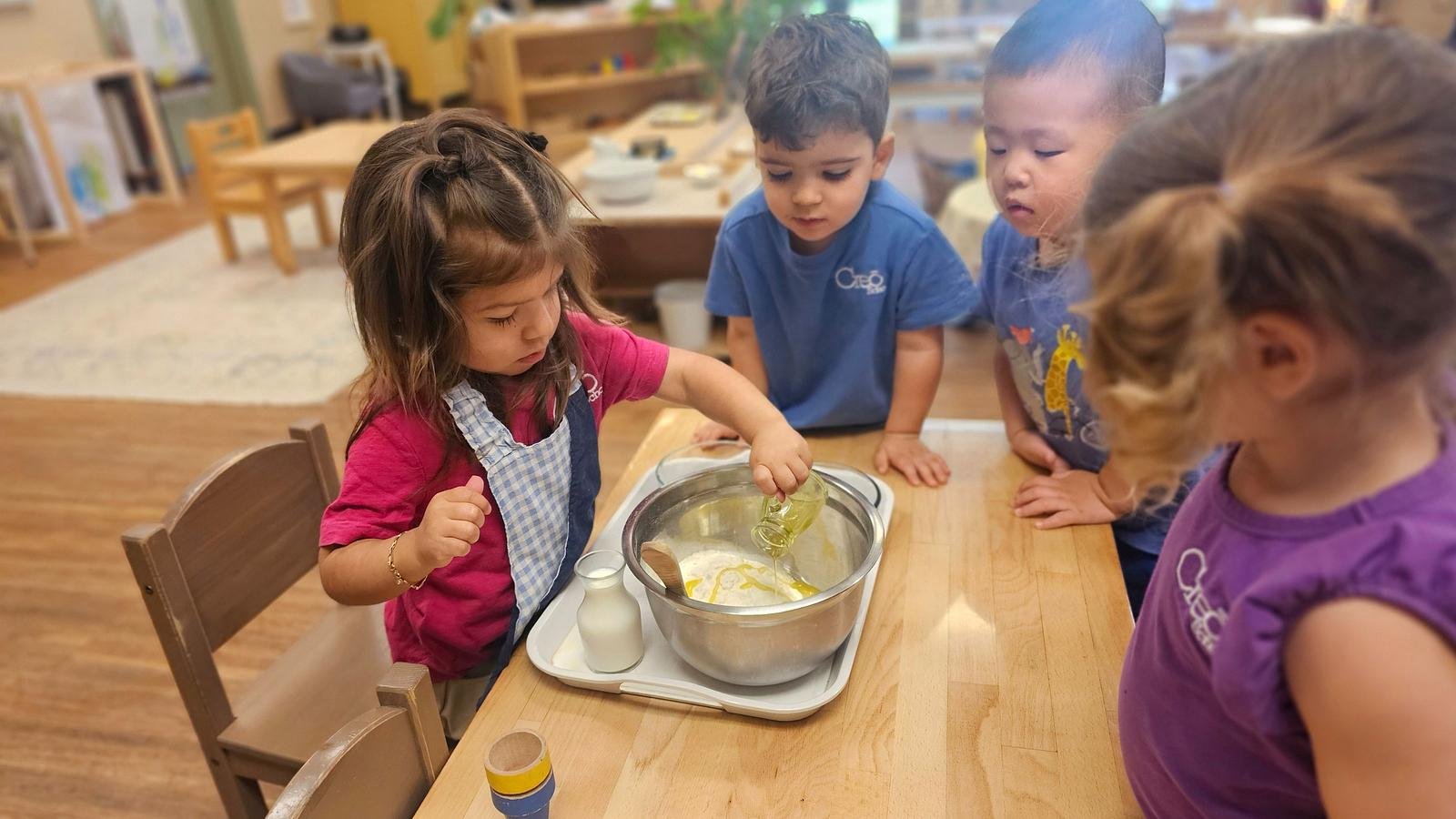 Zara adding oil for blueberry muffins.jpg