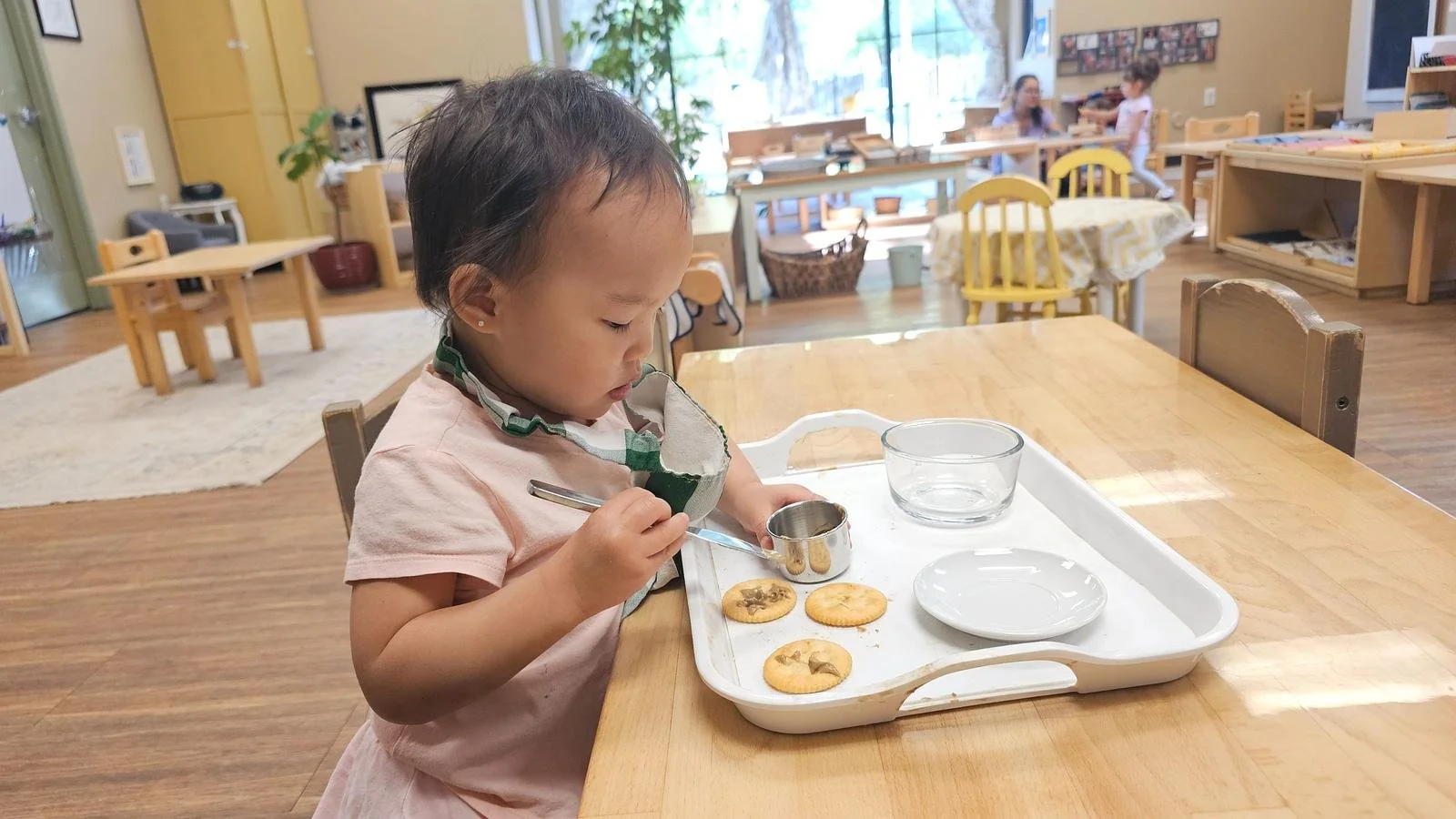Amelia spreading sunbutter on crackers.jpg