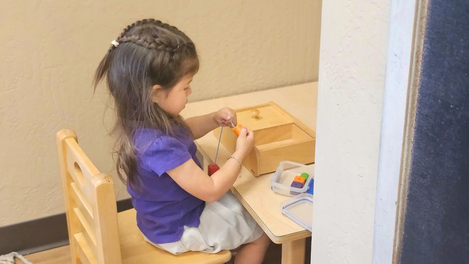 Zara stringing beads.jpg