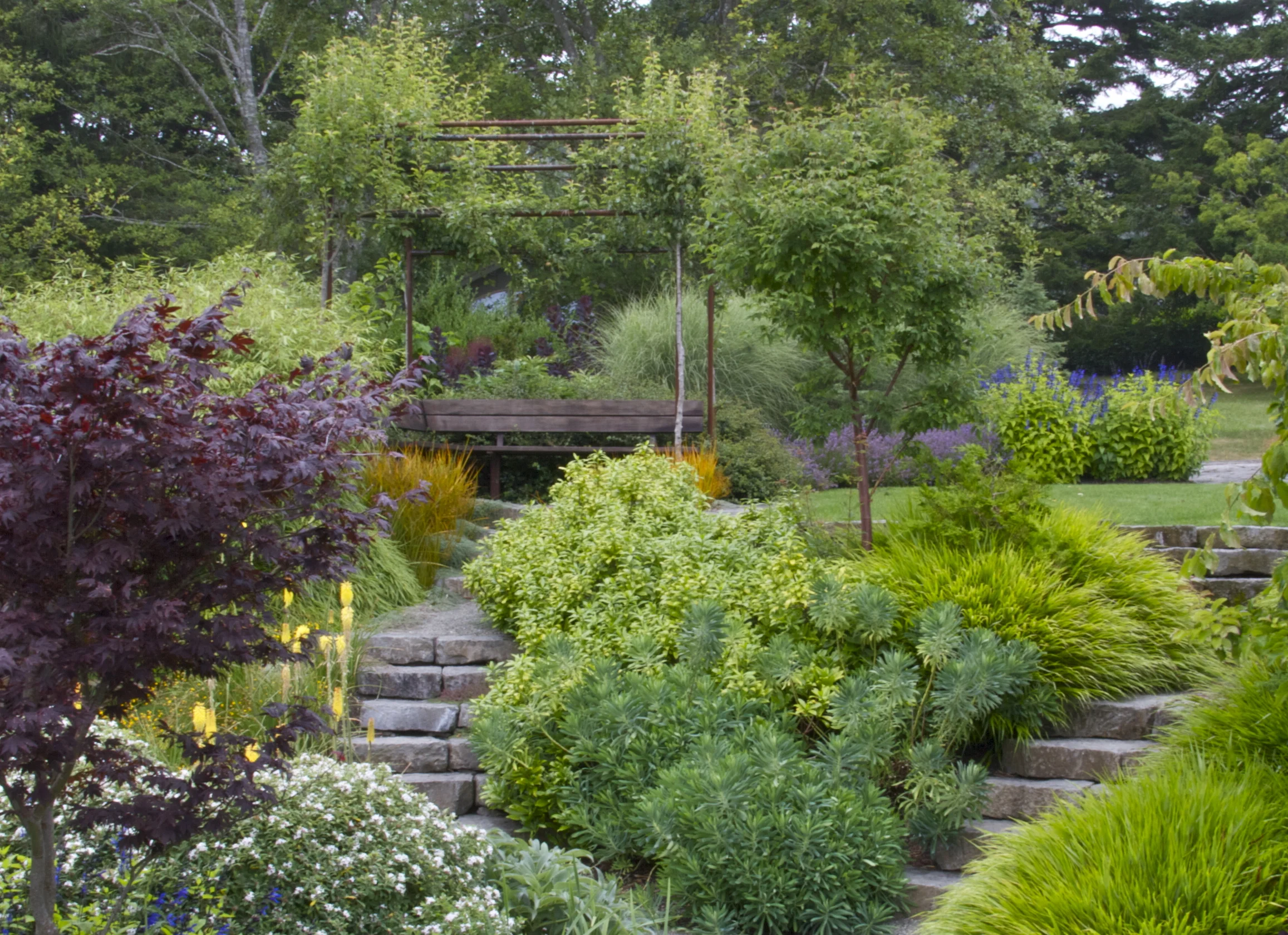 A seating area doubles as a focal point in this garden on the Oregon coast.