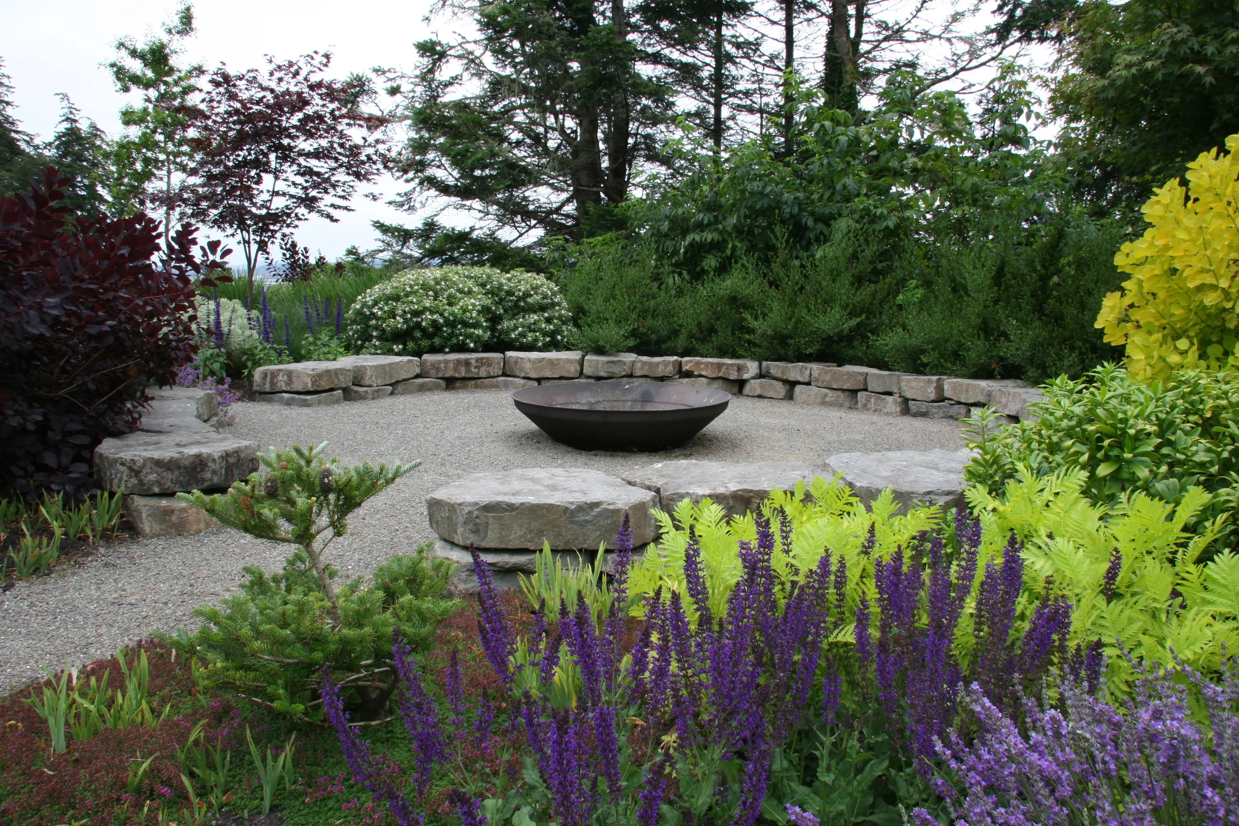 This 20' diameter circular, seating-height stone wall makes a fire pit for a crowd on the Oregon coast.