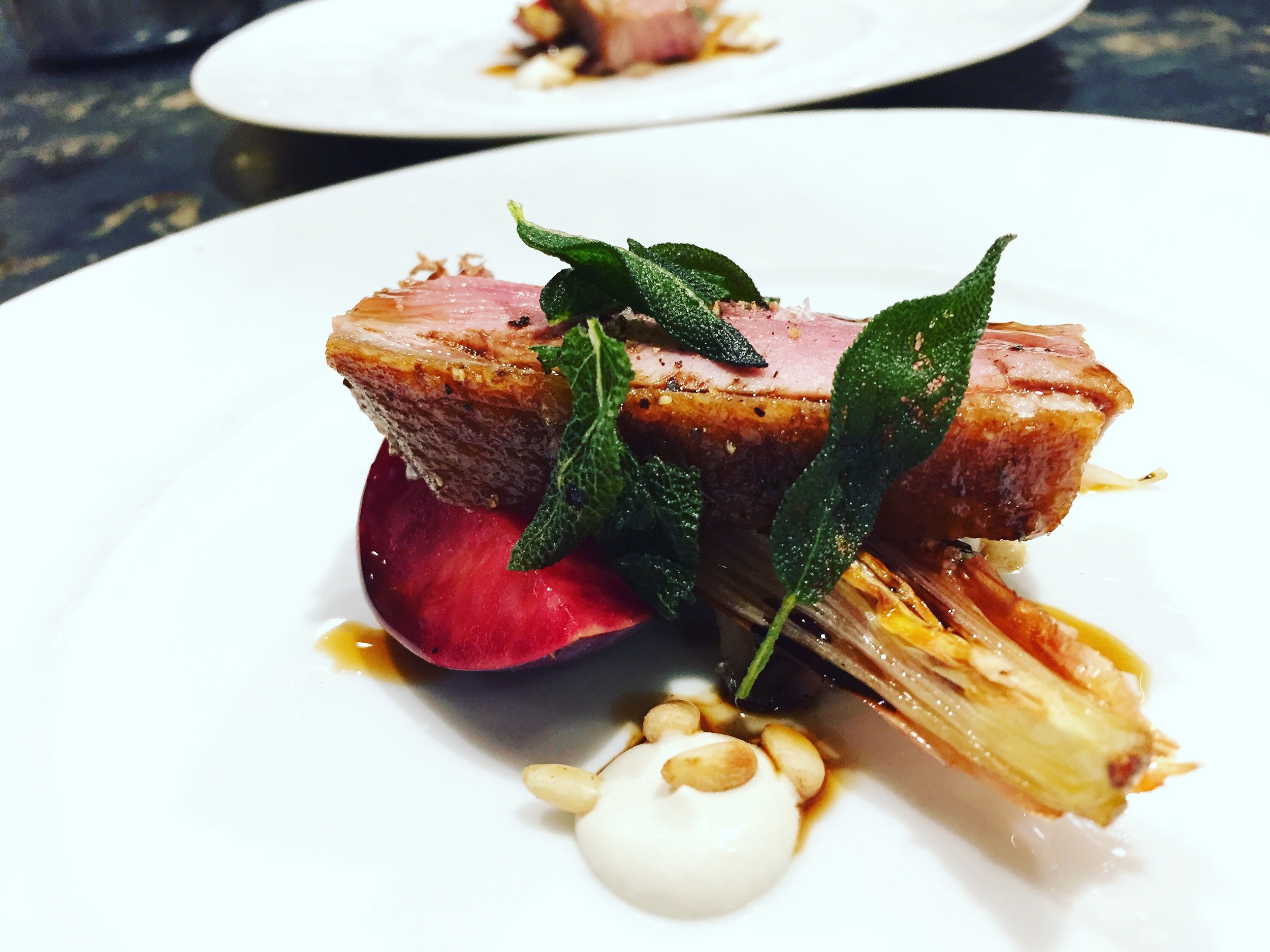 Roasted duck with plum, pine nuts and sage