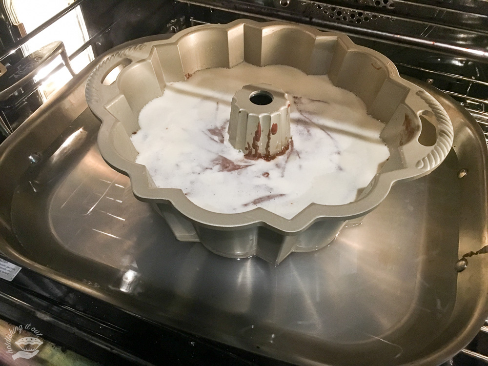 The flan mixture is already sinking to the bottom even before getting it in the oven. Note the water bath. I used a roasting pan, but a 9"x13" pan would work here, too.