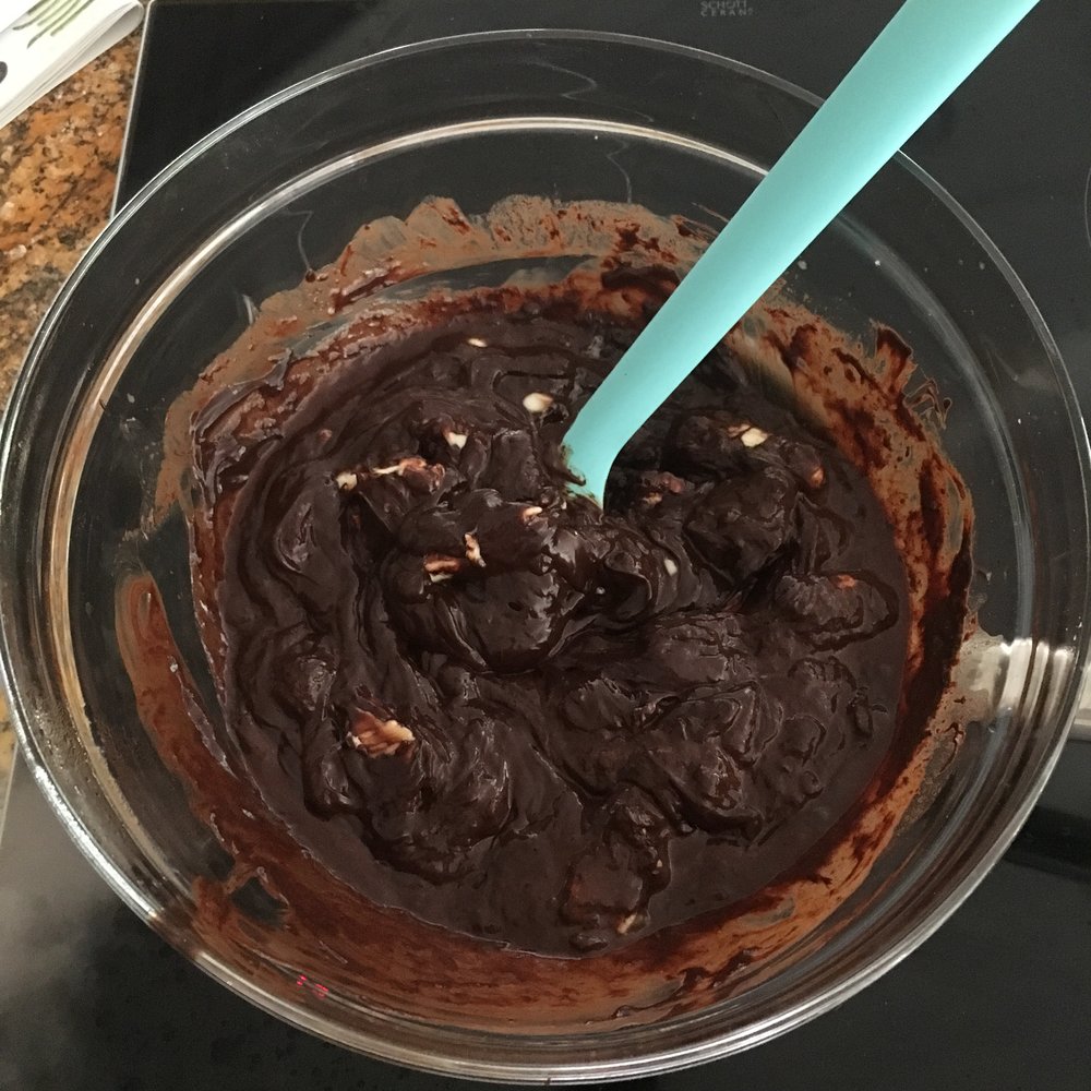 Mixing butter into the chocolate and coffee