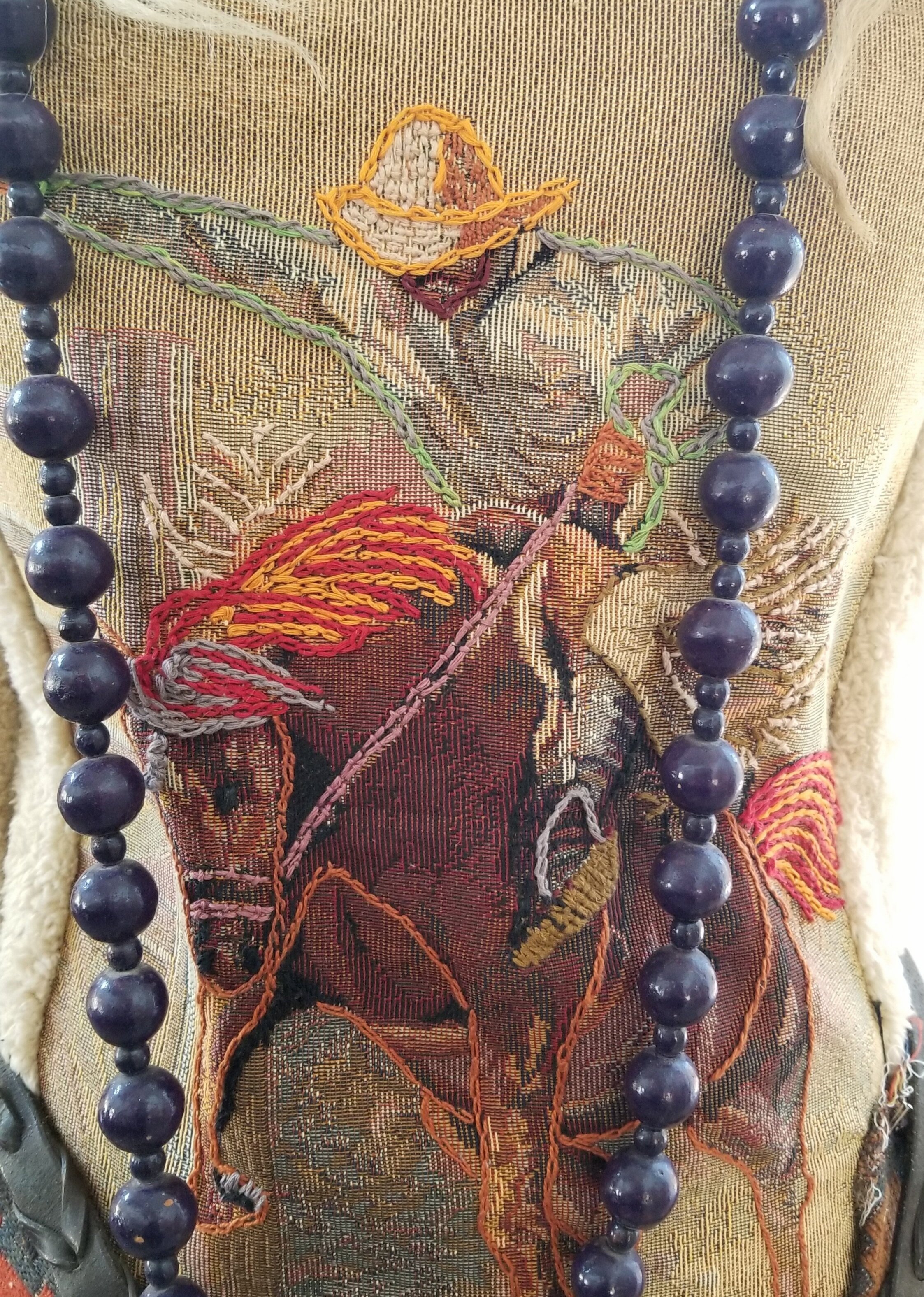 Embroidered bodice (atop the image imprinted on textile) with Colcha and chain stitches