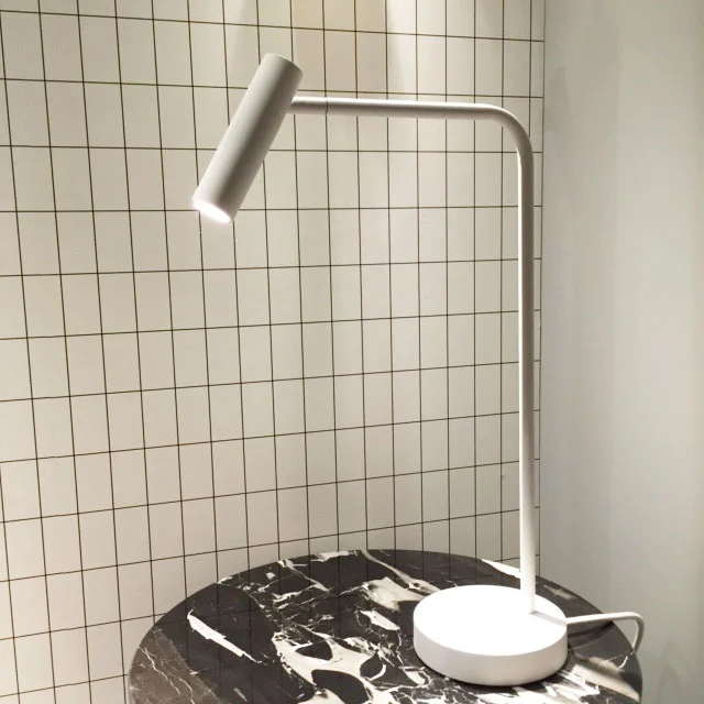 Minimalist lighting styled with marble and grid patterns at Astro