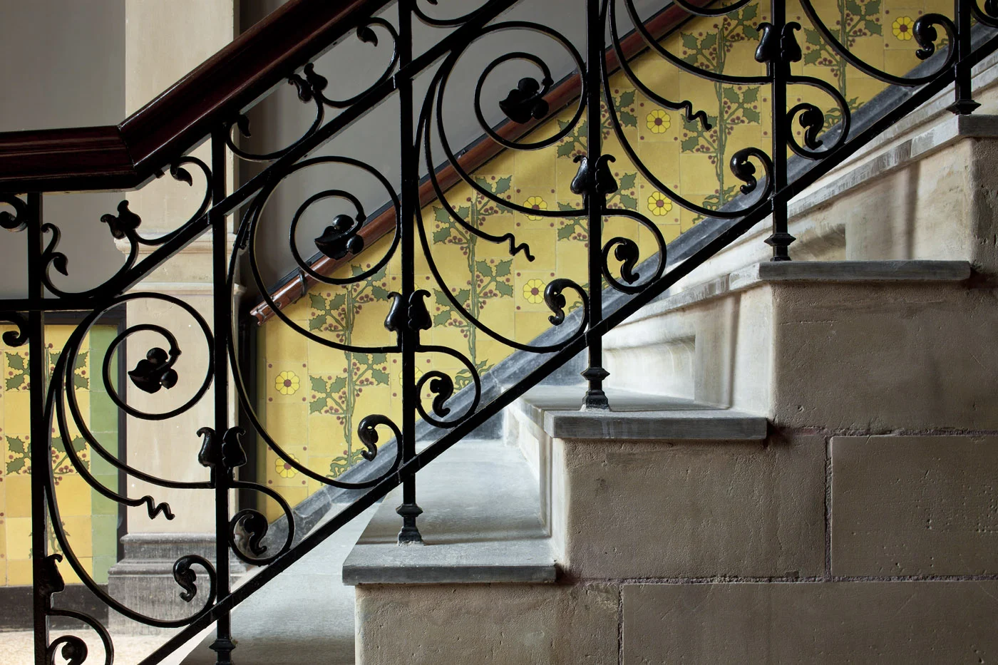 Tiled stone and wrought iron staircase at The Conservatorium Hotel Amsterdam | Design Hunter