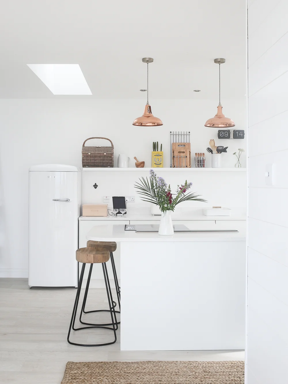 White Scandi style minimalist kitchen with copper lighting | Design Hunter