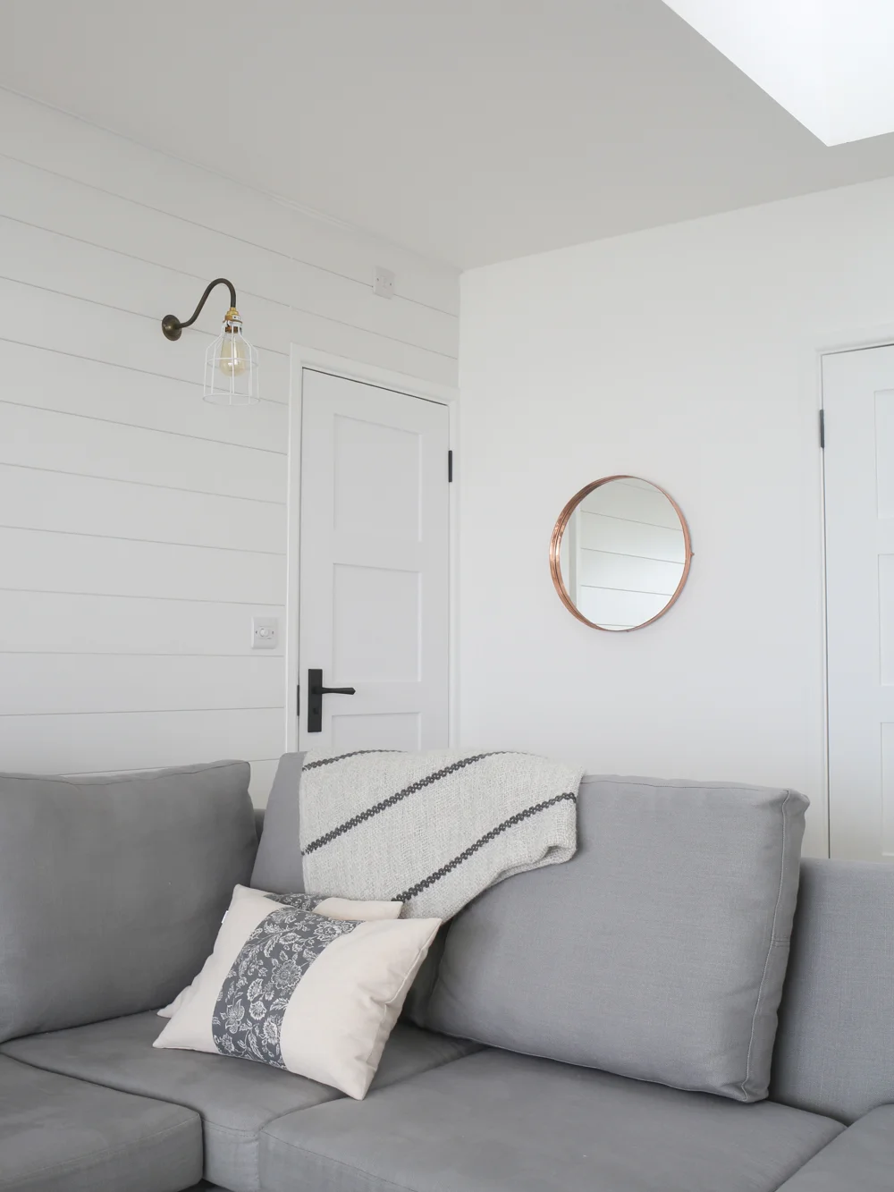 Grey sofa & copper mirror | Design Hunter