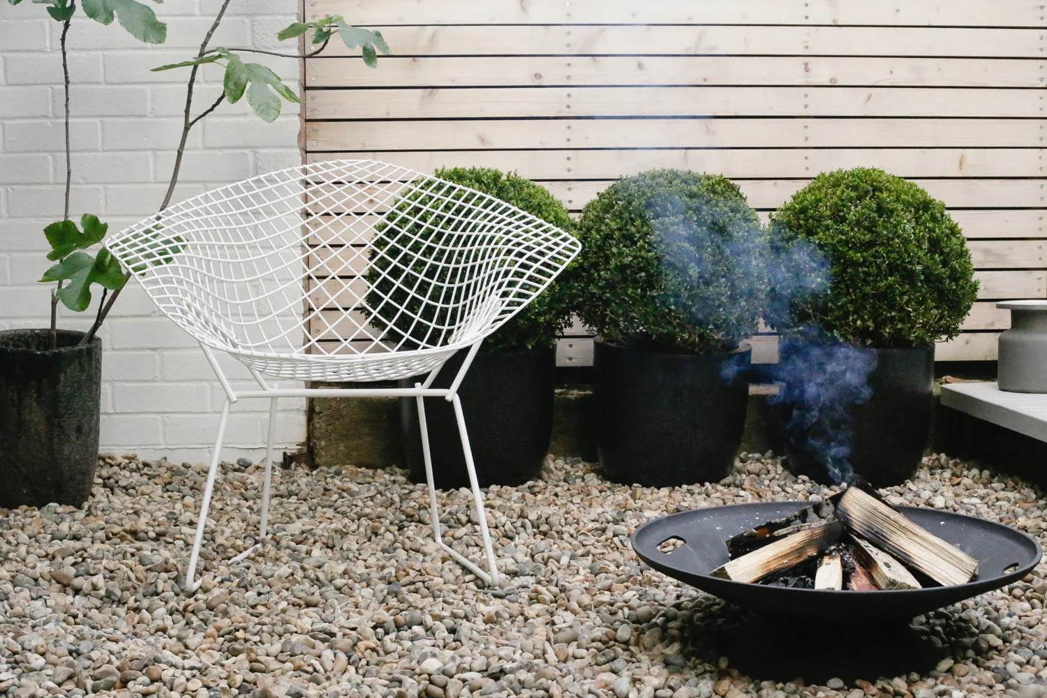 Skagerak firebowl and Bertoia chair | Design Hunter