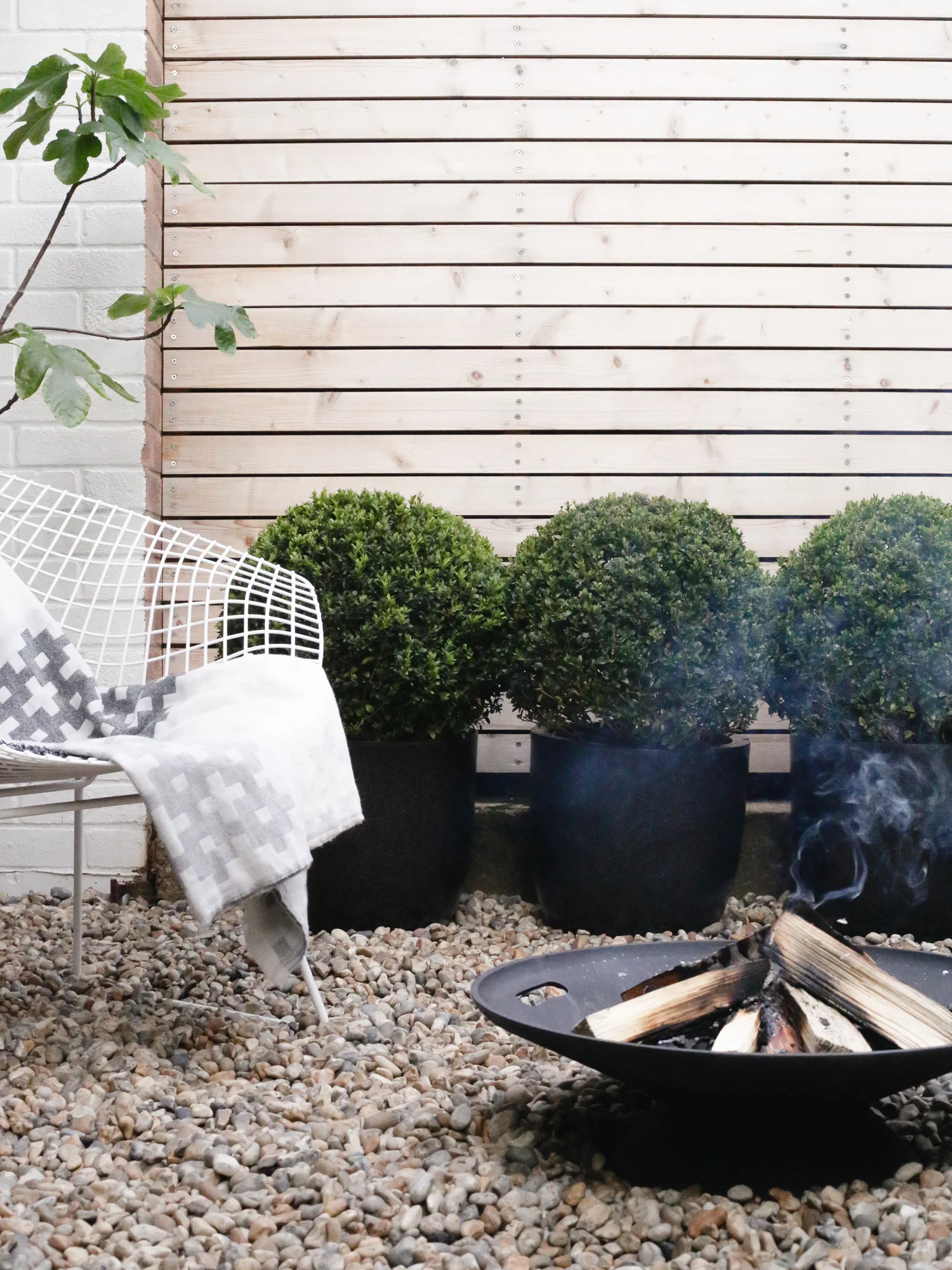 Skagerak firebowl and Bertoia chair | Design Hunter