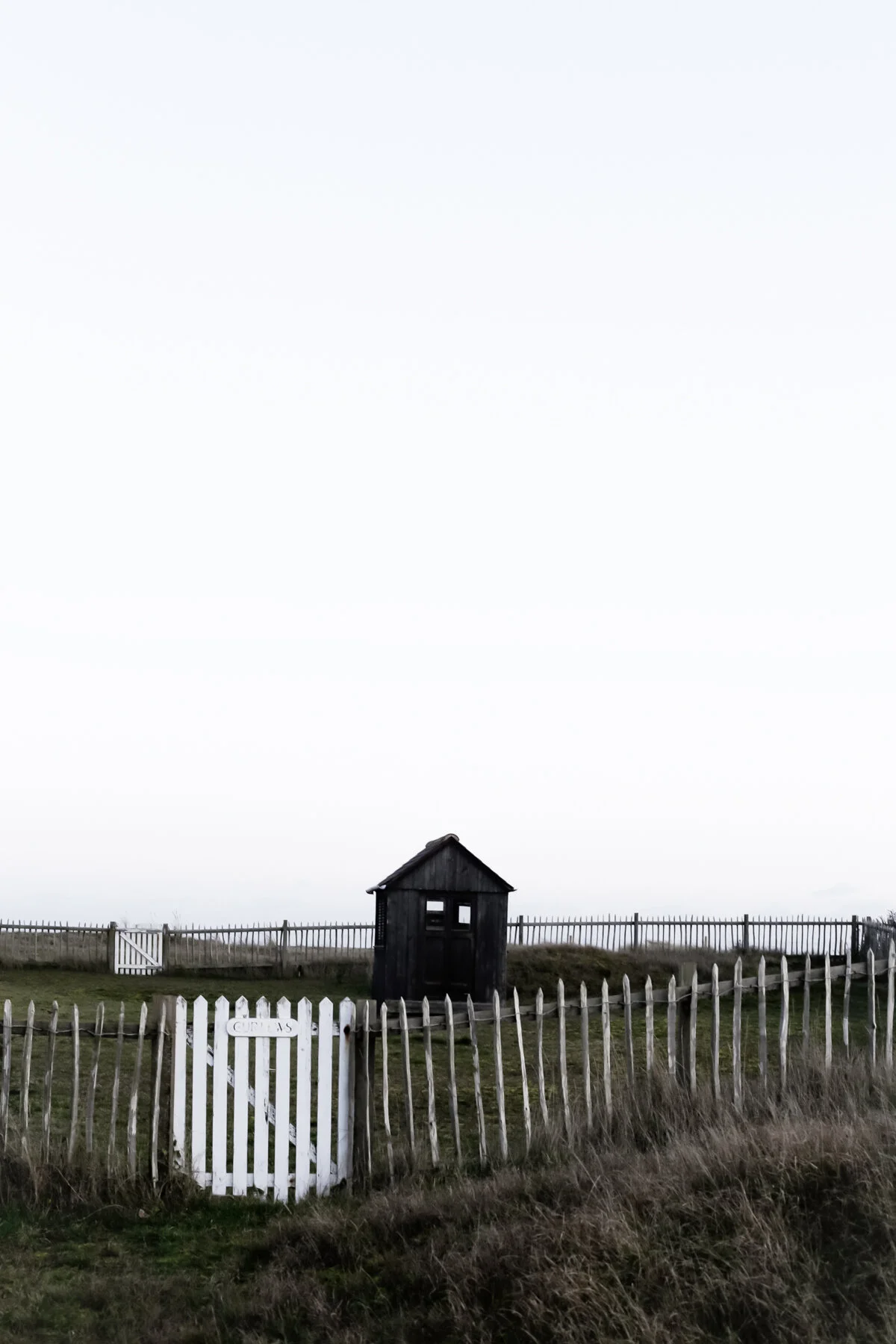 Black wooden shed on the beach at Thorpeness.jpg