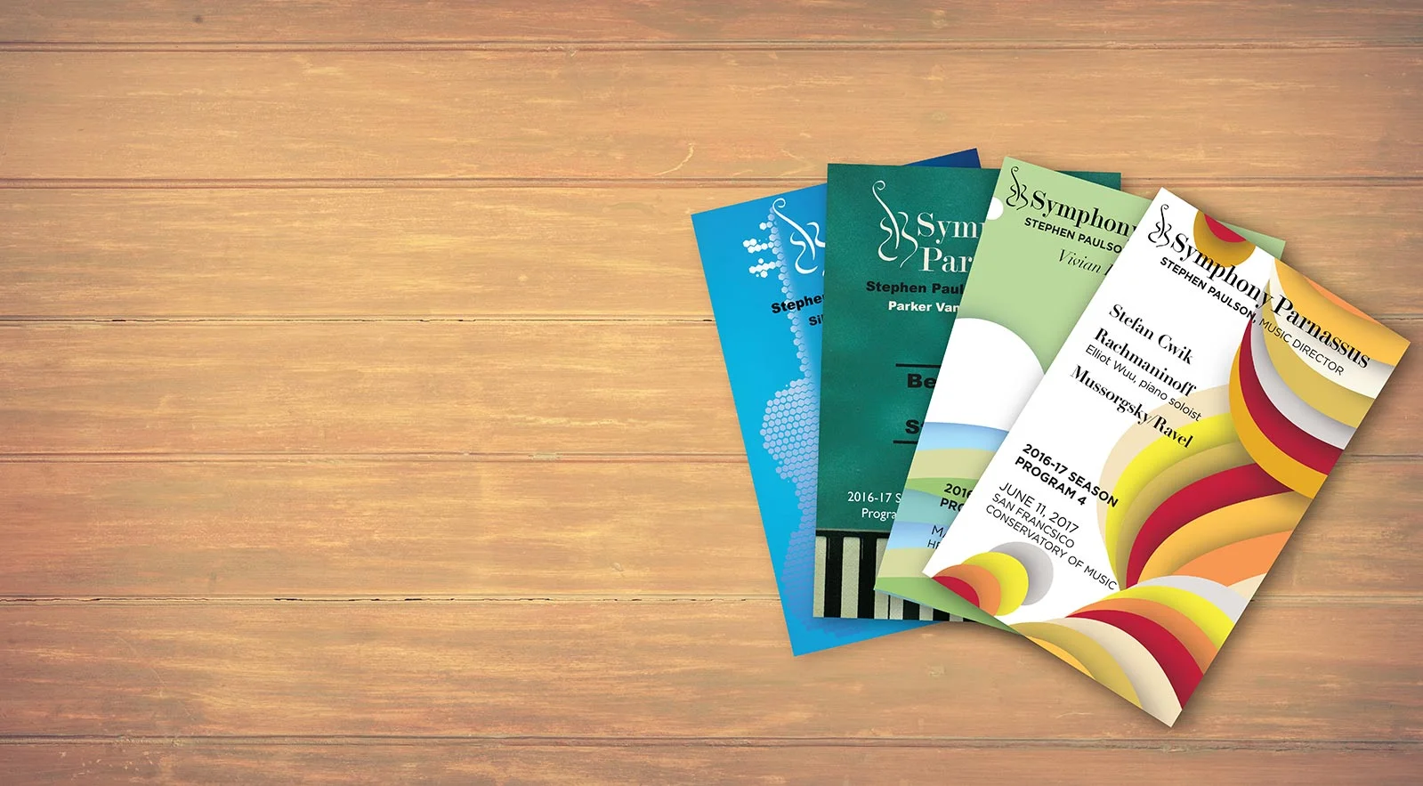 Advertise - Stack of programs wood background reduced.jpg