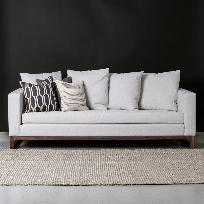 This is an amazing sofa from West Elm upholstered in Cement. The long continuos cushion adds a modern flair but the wood base feels rustic which is a nice balance. 
