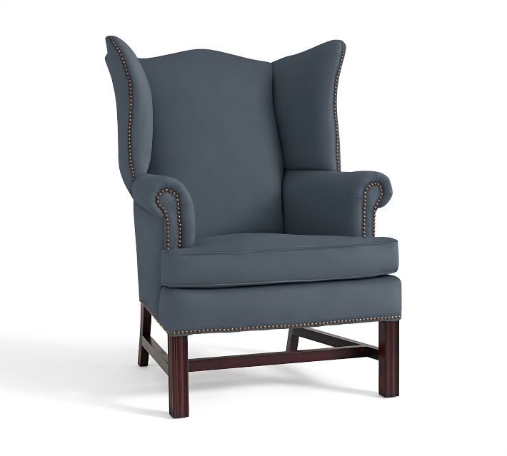 I love this wing chair from Pottery Barn upholstered in brushed canvas color harbor blue. This piece has a colonial feel which is a nice contrast to the modern sofa. I love the nailhead details! 