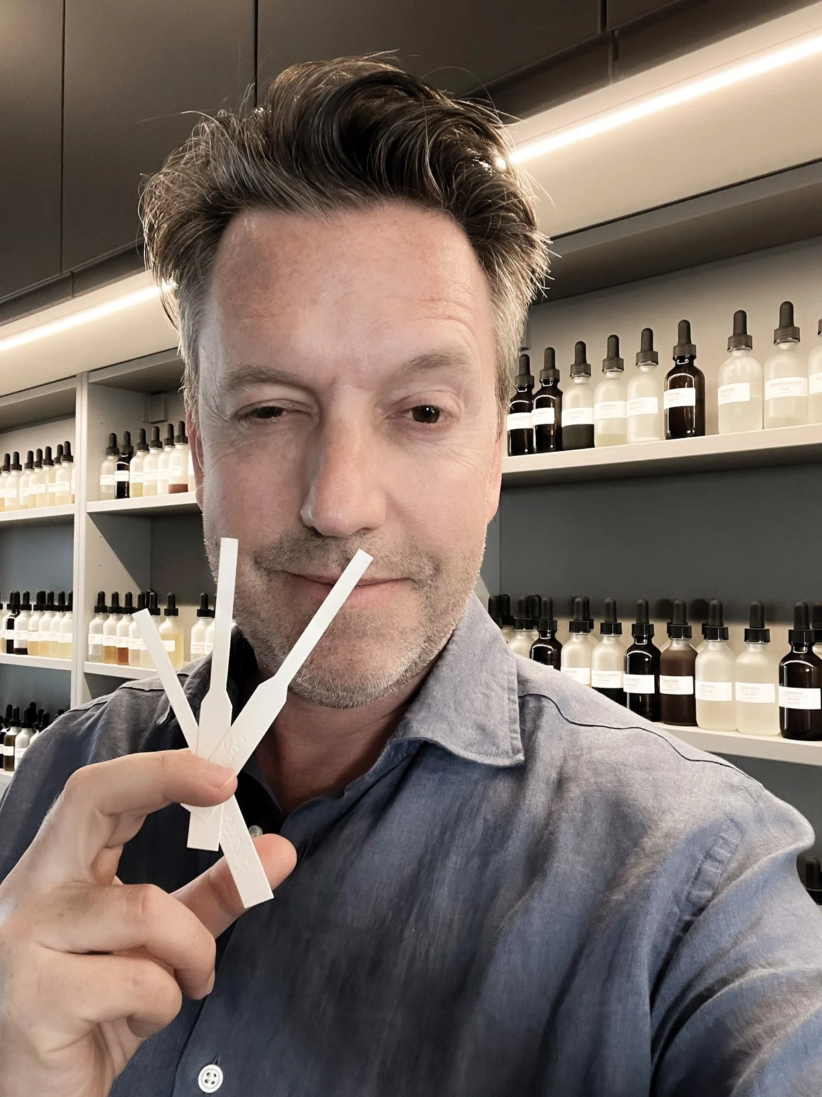 Christopher Draghi, nose of source adage fragrances, with tester strips