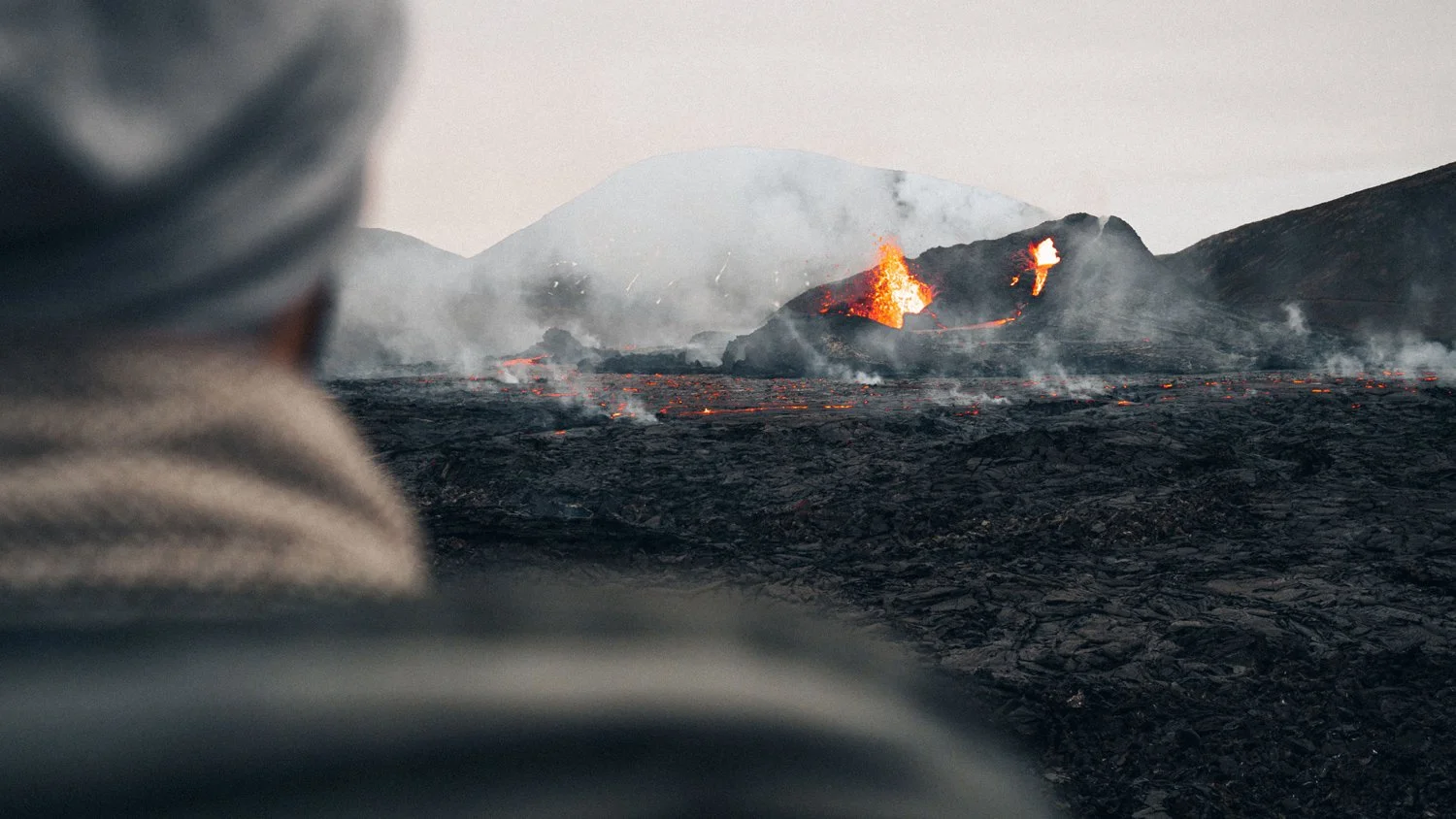 Looking over the shoulder of an observer at a Volcanic plain.