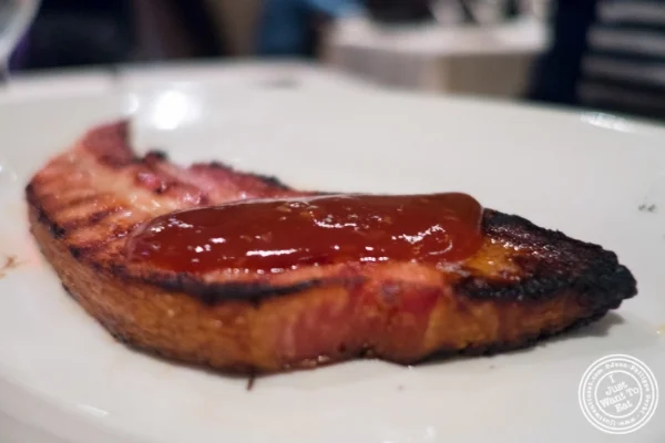 Thick slab of Canadian bacon at Angus Club Steakhouse in New York, NY